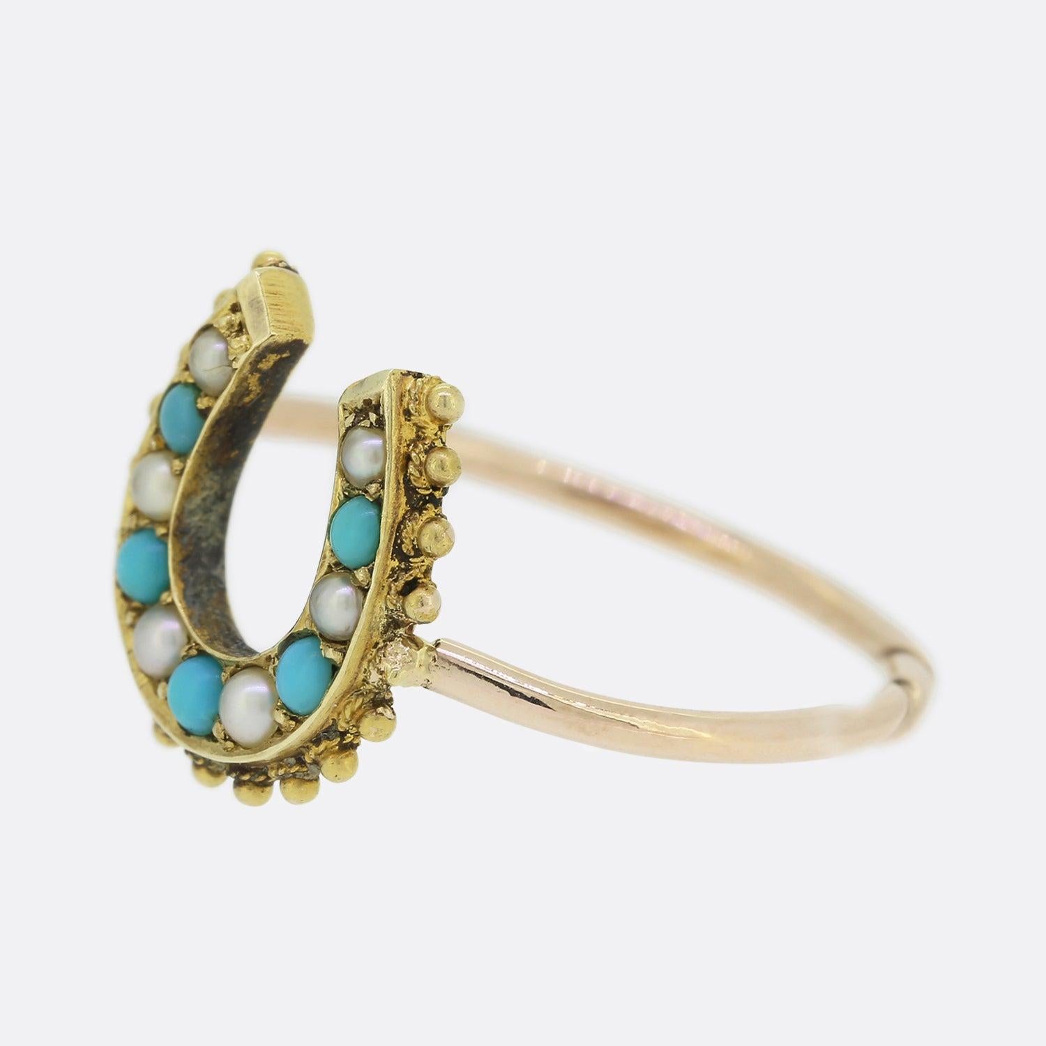 Here we have a fabulous turquoise and pearl ring originally dating back to the Victorian era. The face has been crafted into the shape of a lucky horseshoe, a common symbol associated with jewellery of the time. This particular horseshoe showcases a