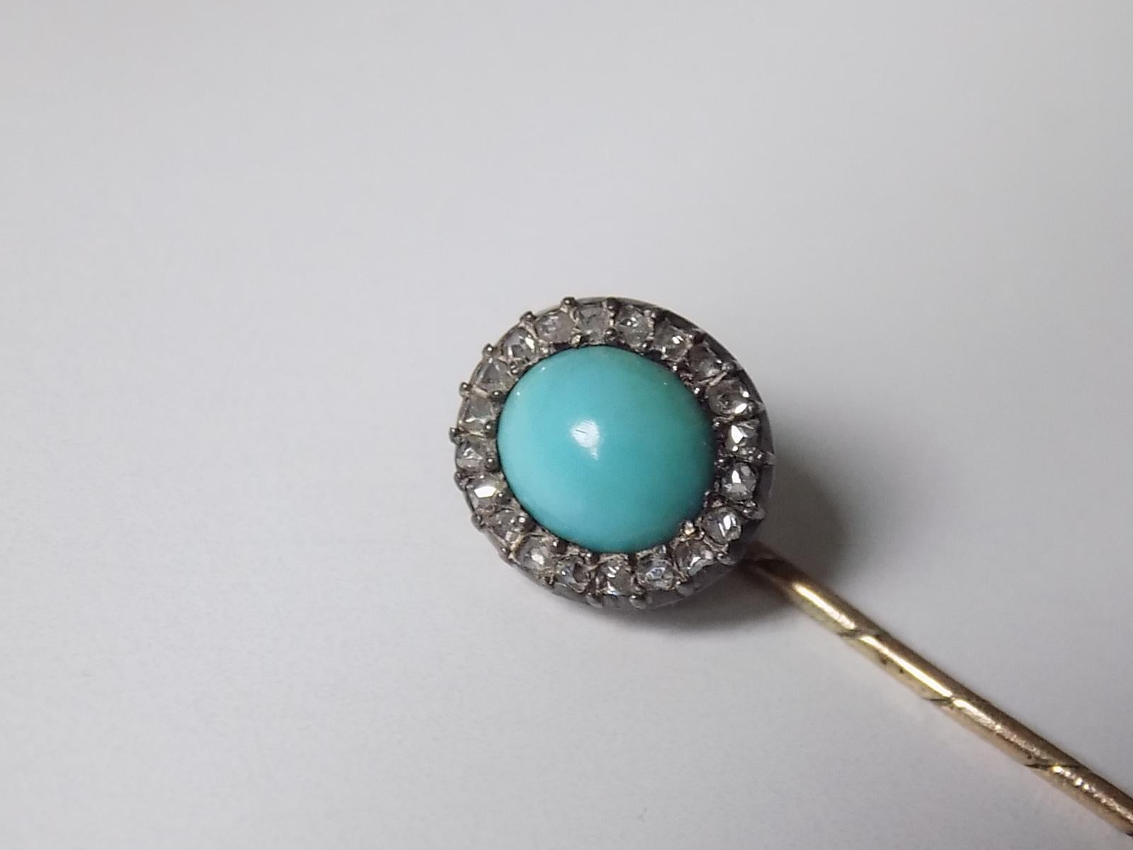 A Victorian c.1890 Rose cut Diamond and Sleeping Beauty Turquoise Stick Pin in Silver and Gold. English origin.
Width of the head 9mm, height 10mm .
Total length of the pin  70mm.
Unmarked.
The pin in good condition for the age, fully complete with