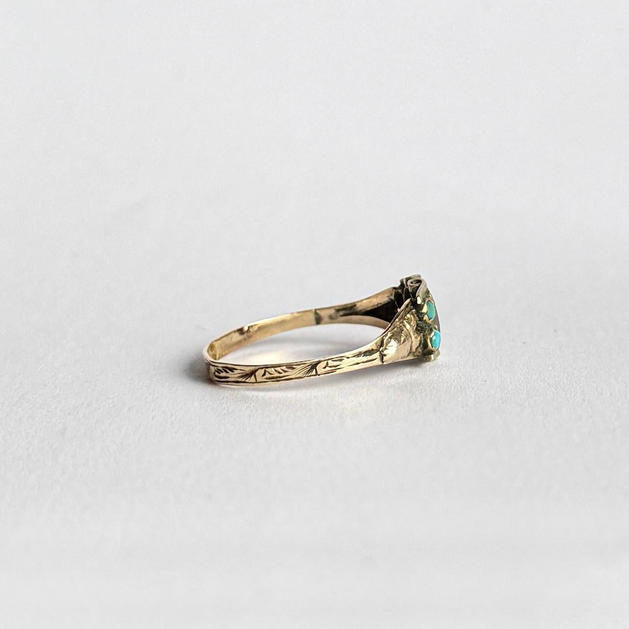This beauty has an incredibly beautiful 9ct gold shank. Sat on top of the swirling detail is a cluster of four bright turquoise and a gorgeous ruby in the middle. The ruby measures 50pts. Fully hallmarked Birmingham 1860. 

Ring Size:  Q or 8