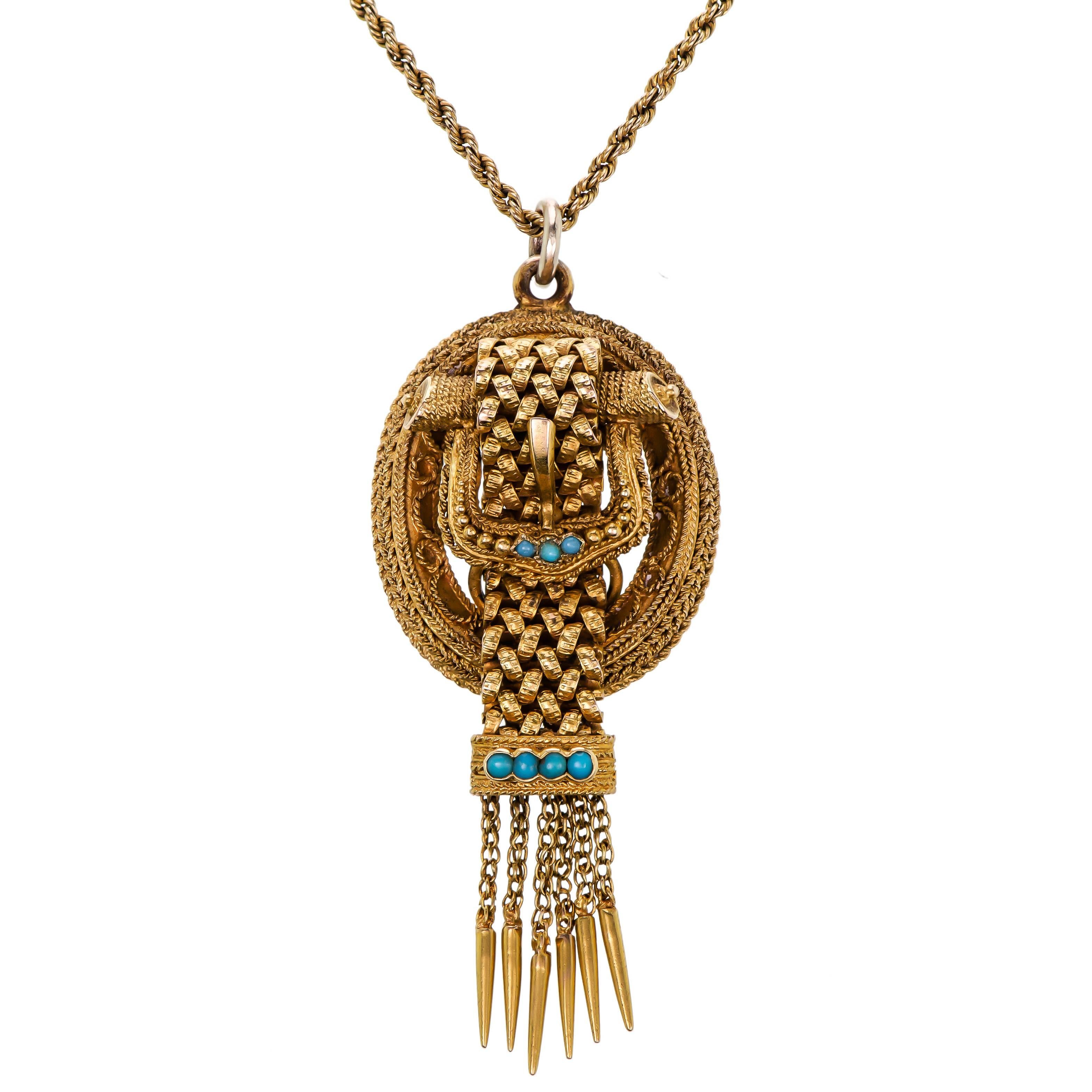 Victorian turquoise and yellow gold buckle motif pendant of a textured yellow gold buckle design set with seven (7) tiny round turquoise cabachons having a central gold mesh link which extends to a chain tassel suspended from an antique lower karat