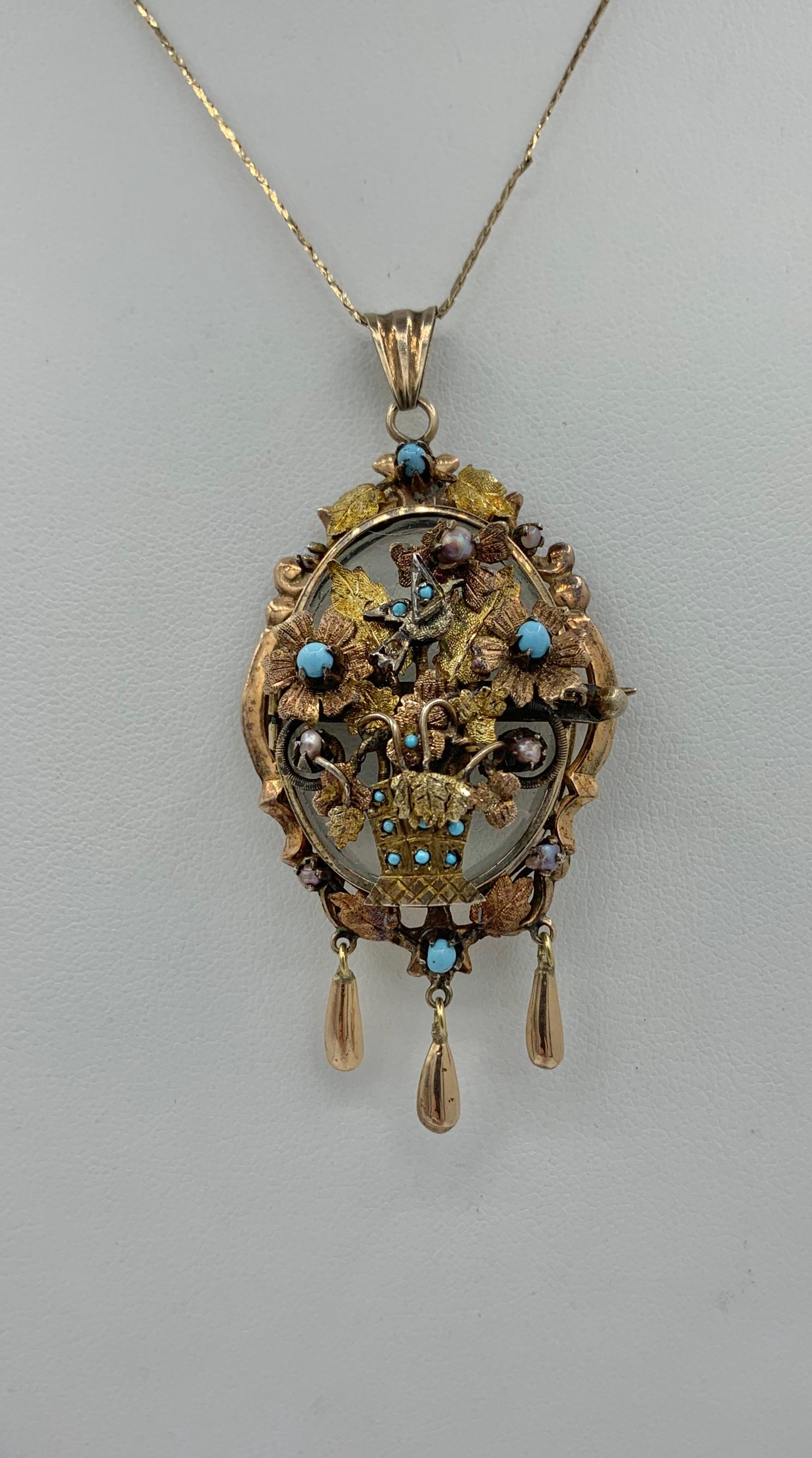 This is a gorgeous and very rare antique Victorian bird dove locket pendant brooch in 14 Karat Gold adorned with Turquoise and Pearls in an extraordinary three-dimensional design of a flower basket bouquet with a flying bird.  The locket is one of