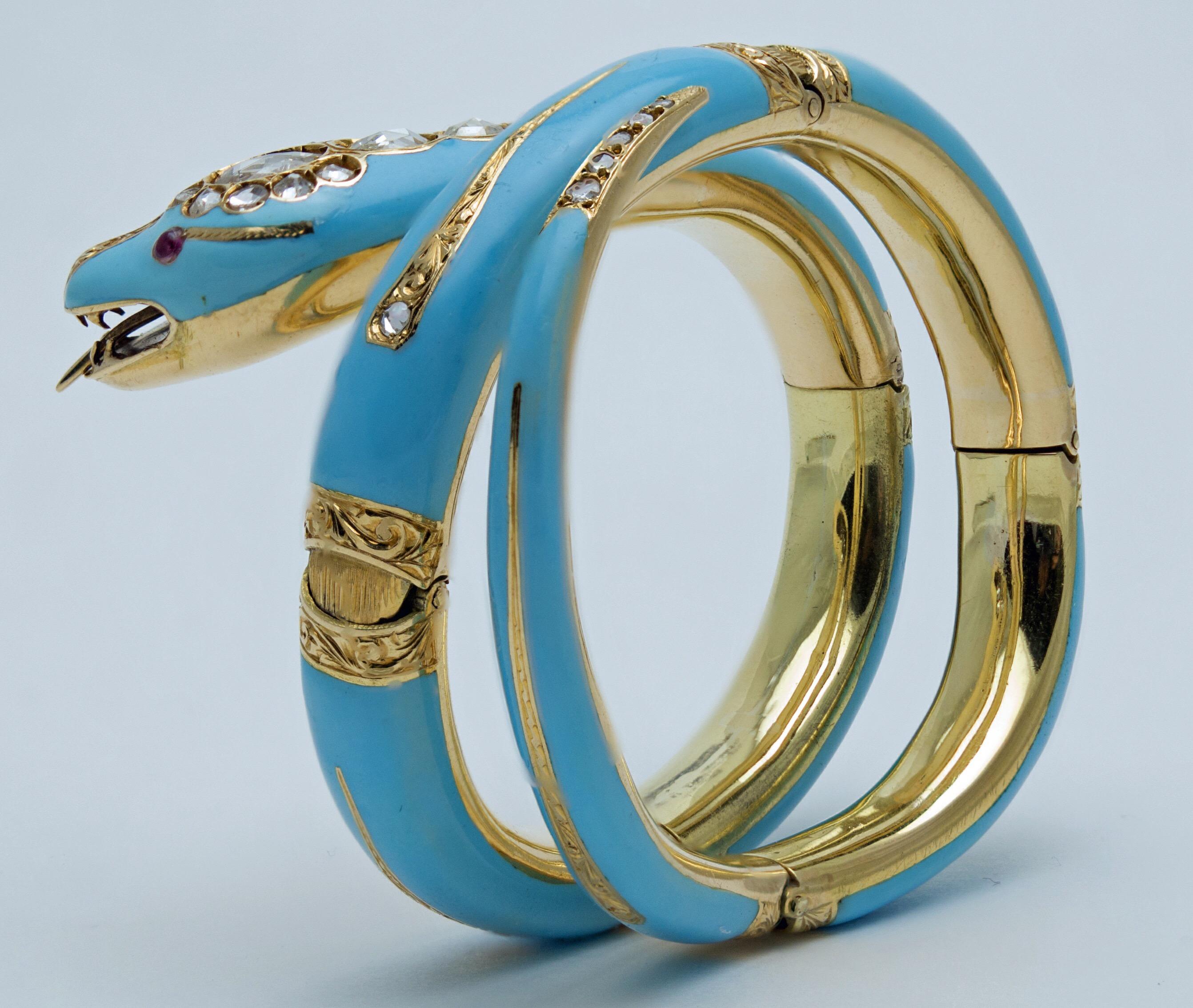 A stunning and elegant triple coiled snake bracelet in a gorgeous turquoise blue enamel over 18k gold, accented with old European cut diamonds and rubies for eyes. With an articulated forked tongue. 
The body of the snake also articulated, with six