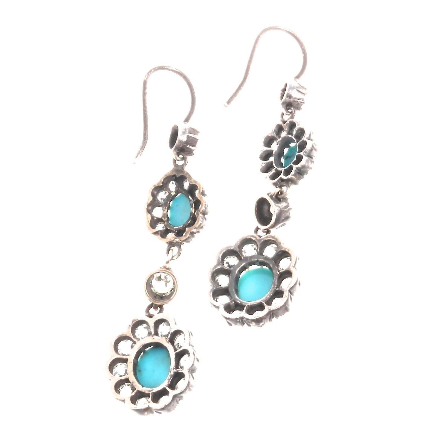 A joyful creation capturing the ever-changing styles of the long lasting victorian era. Featuring elegant drops of near colorless diamonds and beaming cabochon cut turquoise clusters flowing effortlessly down each ear. Hand crafted in 18k gold and