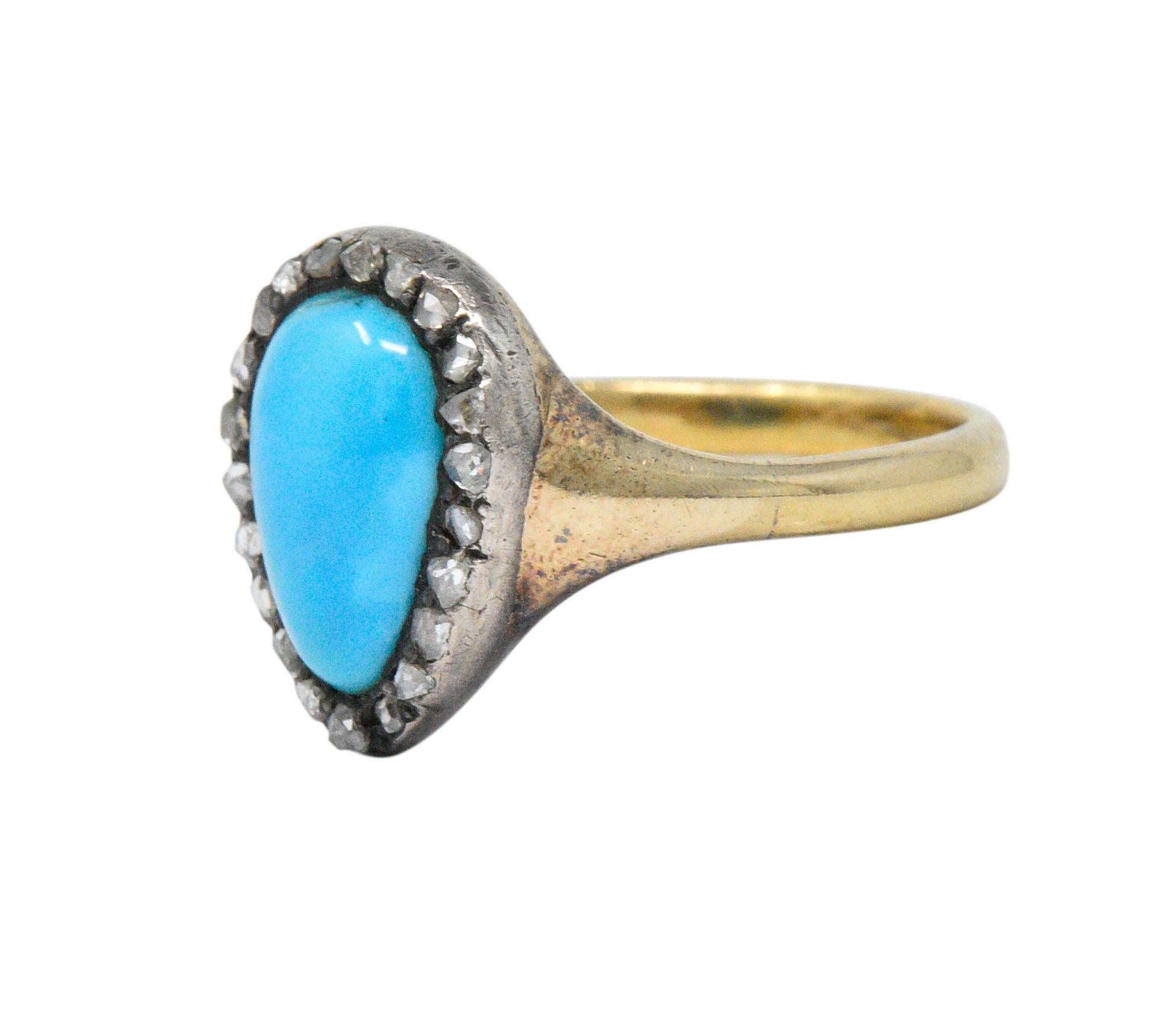 Centering a modified pear shaped cabochon turquoise, measuring 10.8 x 7.2 mm, bright slightly mottled robin's egg blue with slight matrix

Accented by rose cut diamonds, weighing approximately 0.20 carats total

Set in silver with a gold