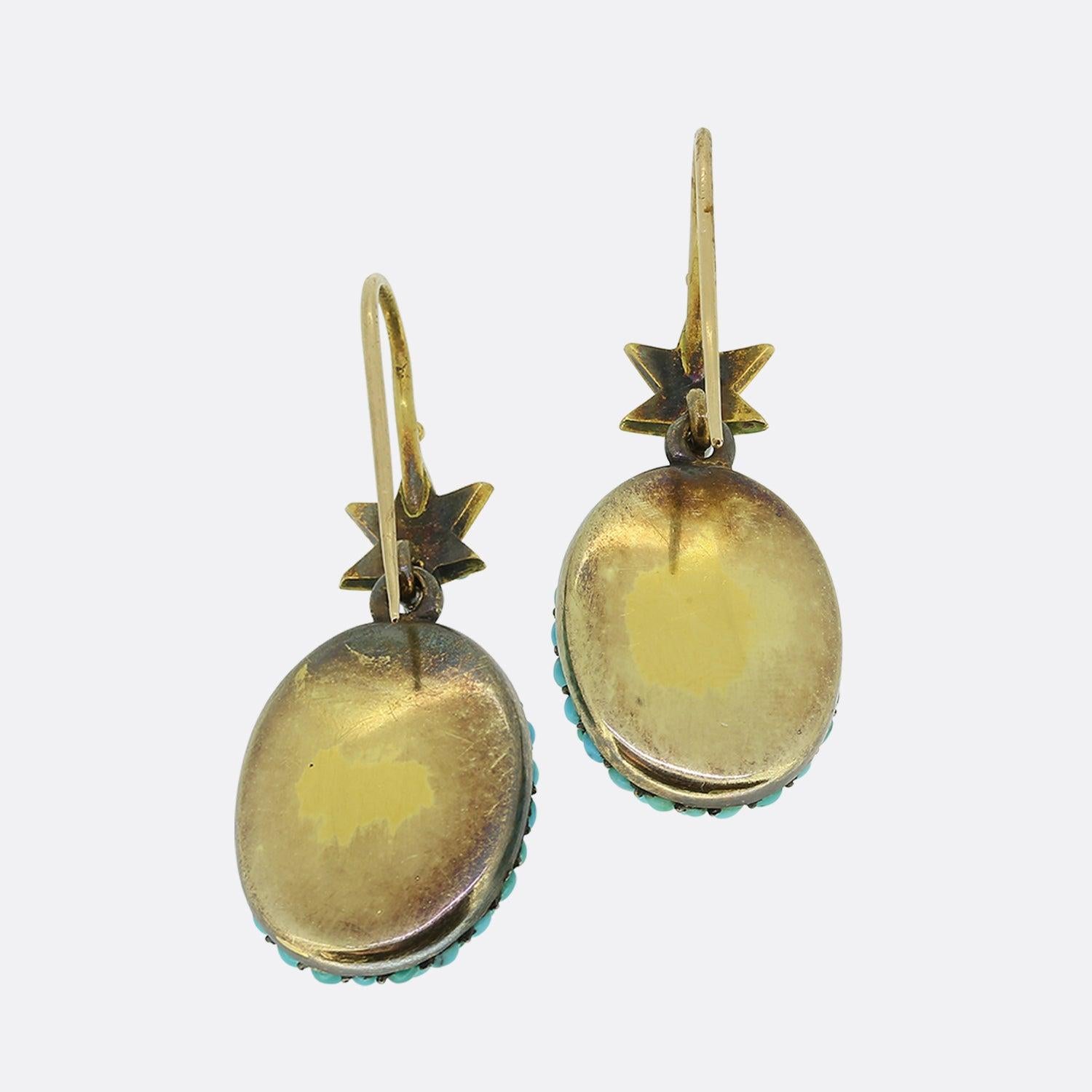 Here we have a tremendous pair of drop earrings which date back to the early Victorian period. Atop each piece sits an expertly handcrafted star motif set with a single tiny round turquoise at each point and a matching oval stone at the centre. This