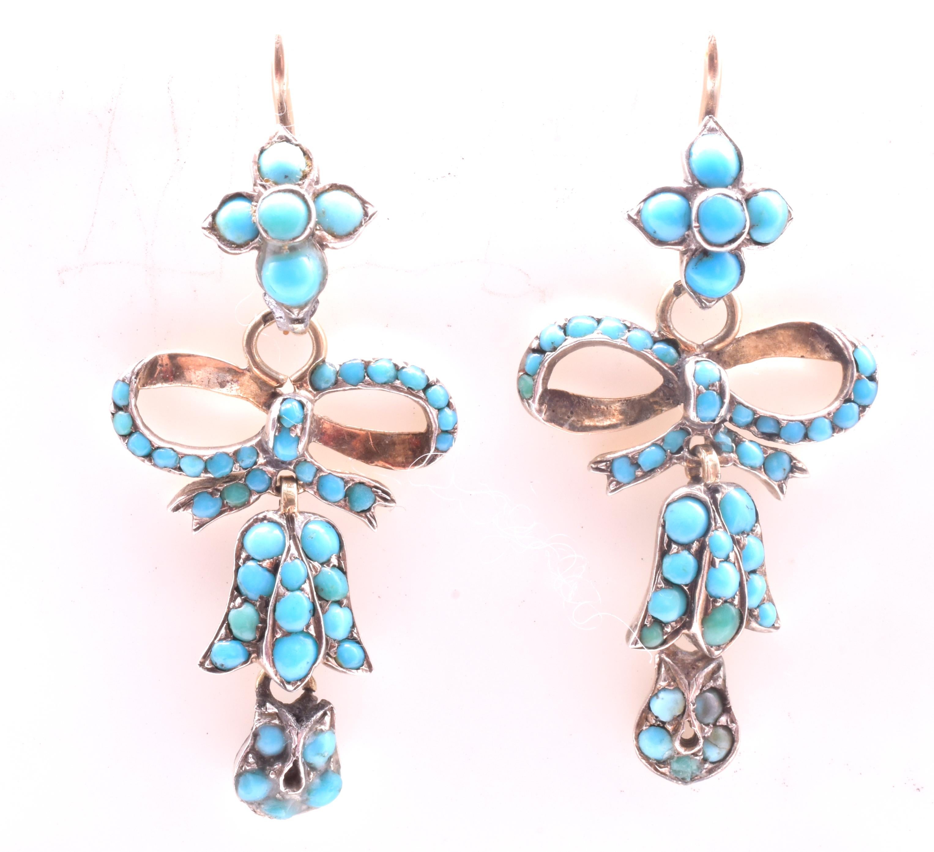 Charming Victorian turquoise silver gilt drop earrings, with daisy form tops and bow bottoms, circa 1880. The earrings are attached to gold shepherds hooks and are 1.4 inches long. Turquoise was considered sentimental love jewelry and the