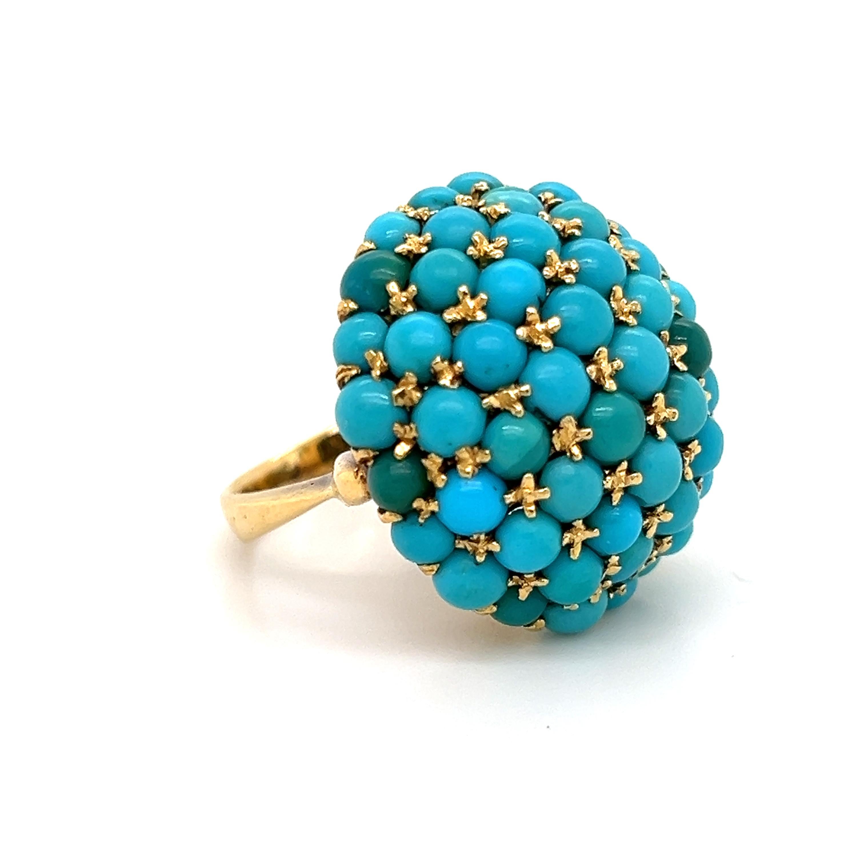 Amazing design crafted in 18k yellow gold. The ring highlights turquoise gemstones, cabochon cut and set in raised curved design also known as 