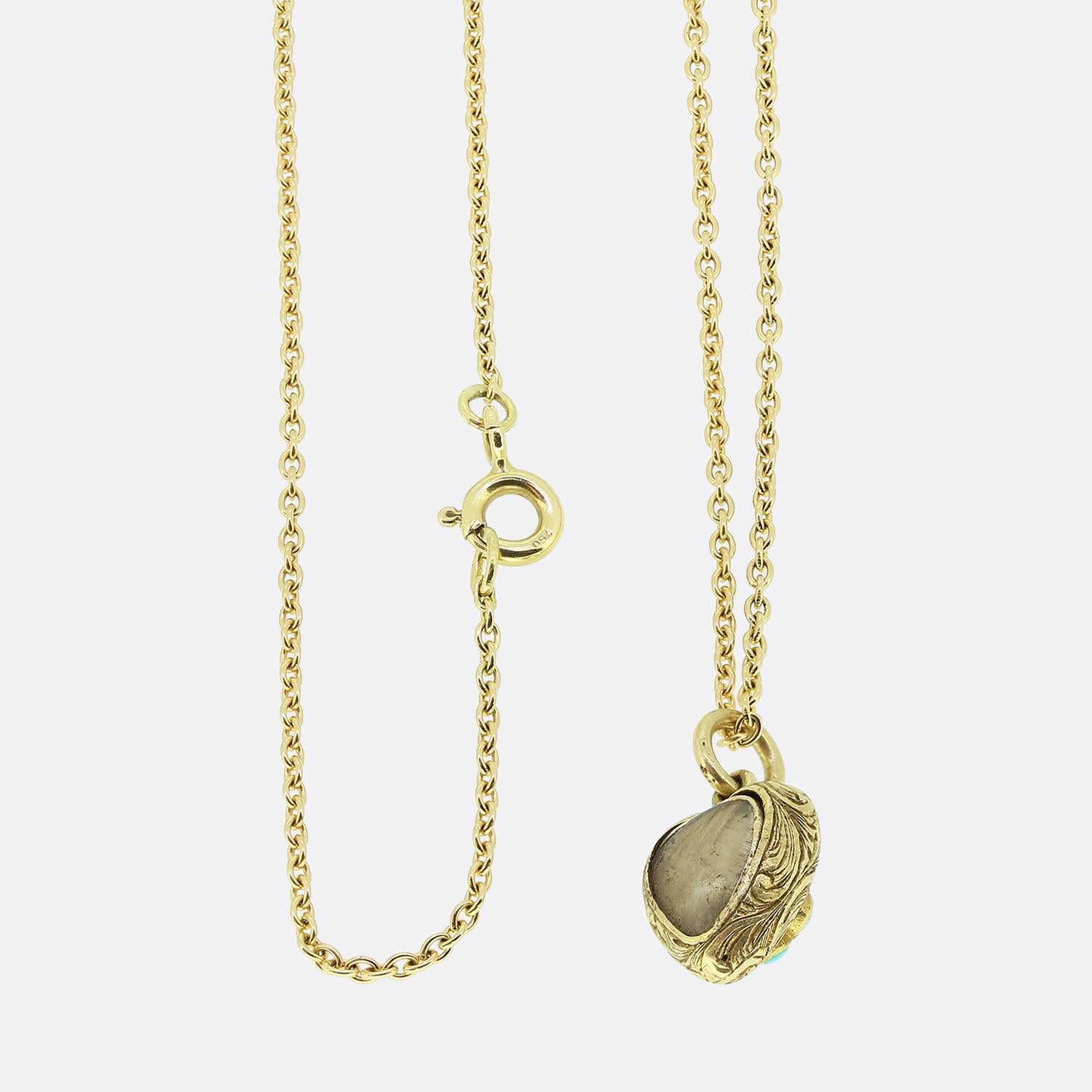 Here we have a delightful turquoise set locket necklace. This antique pendant has been crafted from 15ct yellow gold into the the shape of a little love heart and expertly engraved with a stunning fauna and floral design. This decoration acts as the