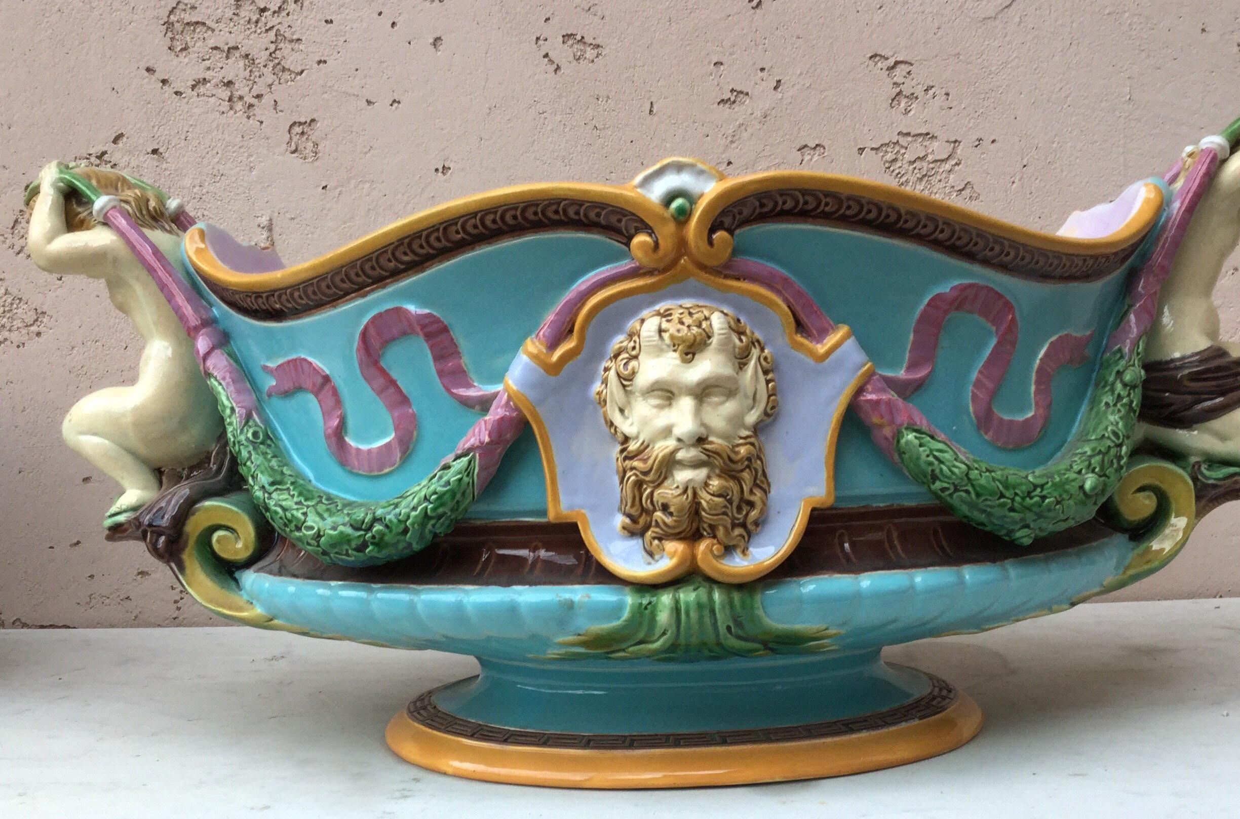 Classical style for this large Majolica jardiniere or table centre signed Minton and dated 1876 cherubs handles and masks on each side of Renaissance Revival. On the middle of 19th century Minton started to produced Majolica highly inspired by the