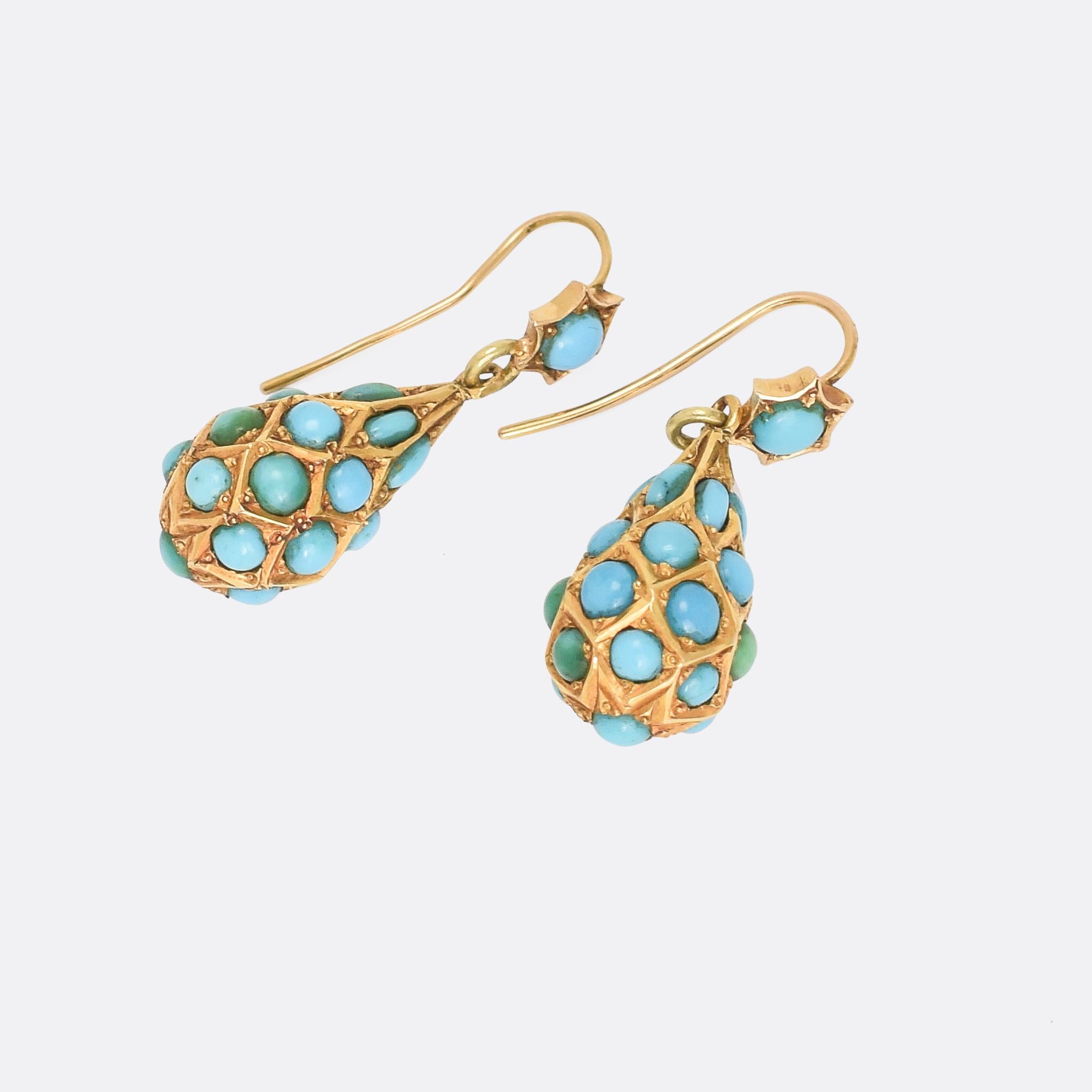 A delightful pair of antique earrings dated from the late Victorian era. each pear-shaped drop is studded with Persian turquoise cabochons all around, and dangles freely from a turquoise-set ear wire. They're particularly well made, crafted in 15k