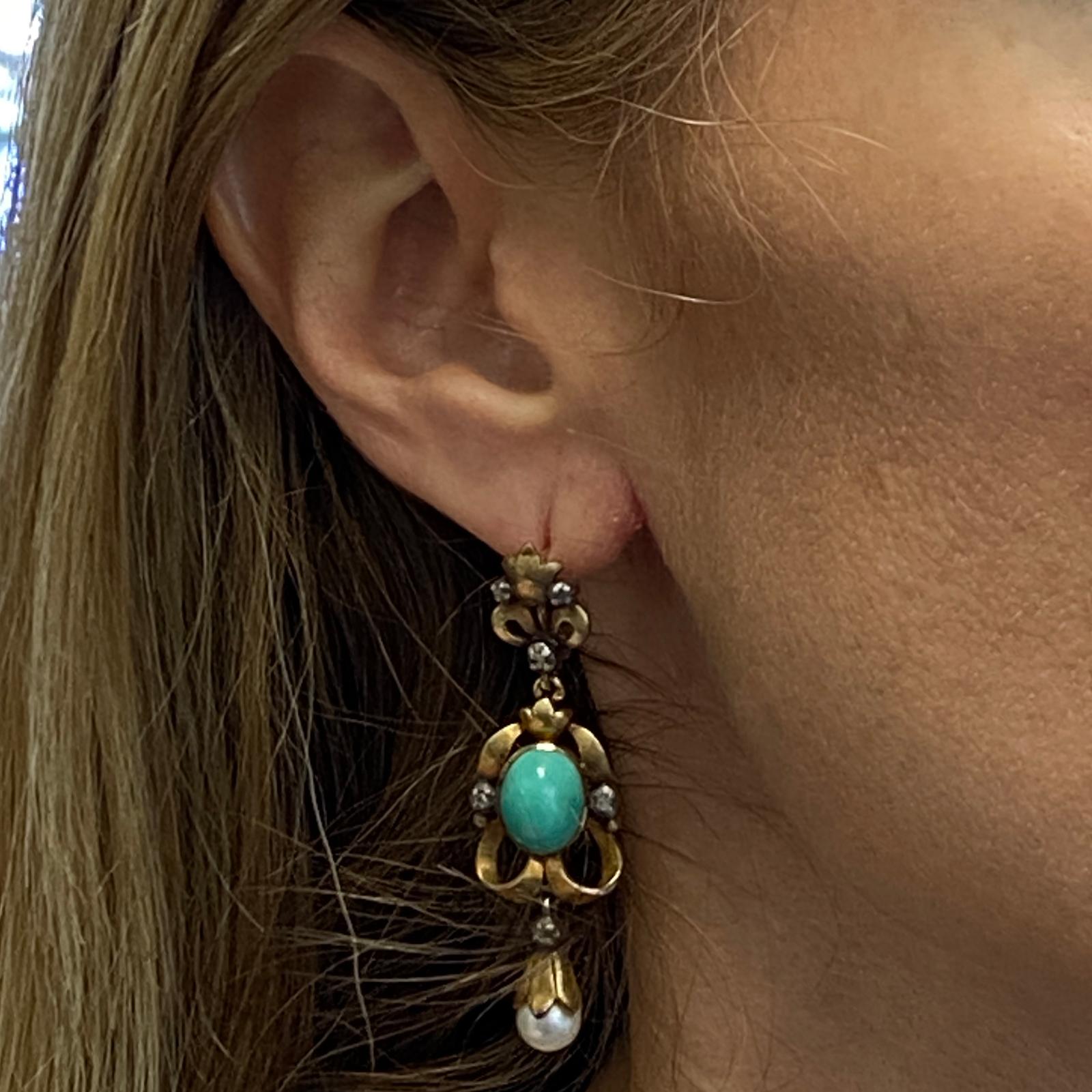 Beautiful Victorian dangle earrings handcrafted in 18 karat yellow gold. The earrings feature turquoise gemstones, rose cut diamonds, and pearl drops. The 12 rose cut diamonds weigh approximately .04 carat total weight.  The earrings measure 2.00