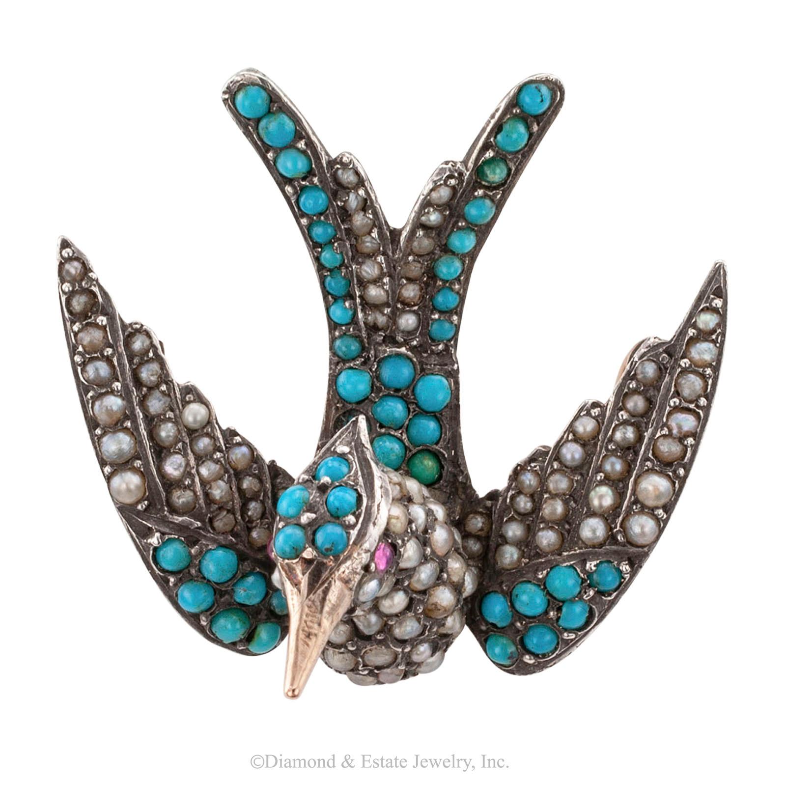 Victorian turquoise pearl ruby silver and gold phoenix bird brooch.

DETAILS:
Victorian phoenix bird turquoise pearl ruby silver and gold brooch circa 1880.
GEMSTONES: pearl, turquoise and ruby.
METAL: silver, gold.
MEASUREMENTS: approximately 1