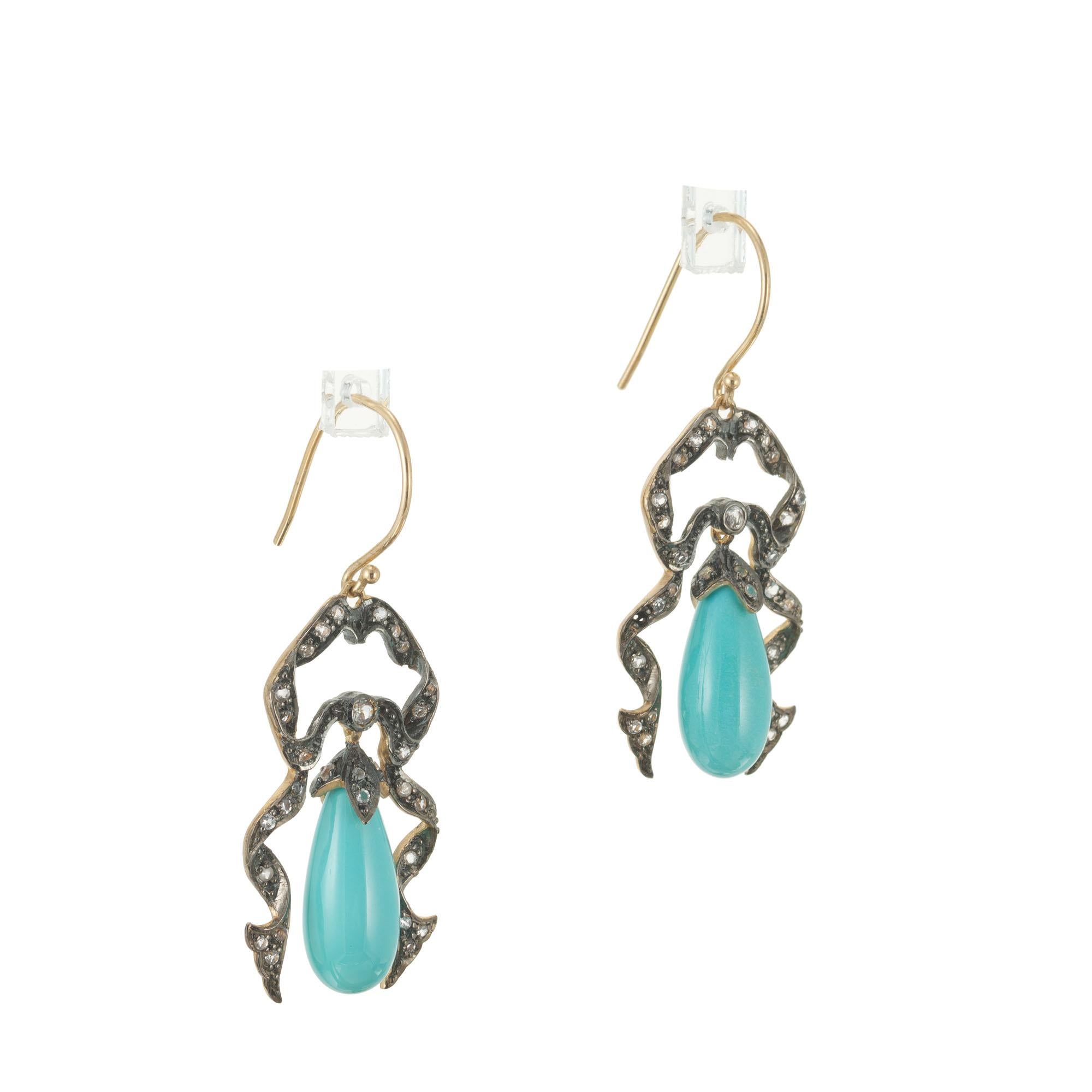 Victorian Revival Turquoise and diamond dangle earrings. 9k yellow gold ribbon style frames with 60 round diamonds and two pear shaped turquoise dangles. 

15 x 7mm pear Turquoise
60 round diamonds, approx. total weight .40cts, H to I, SI1 - I
5.9