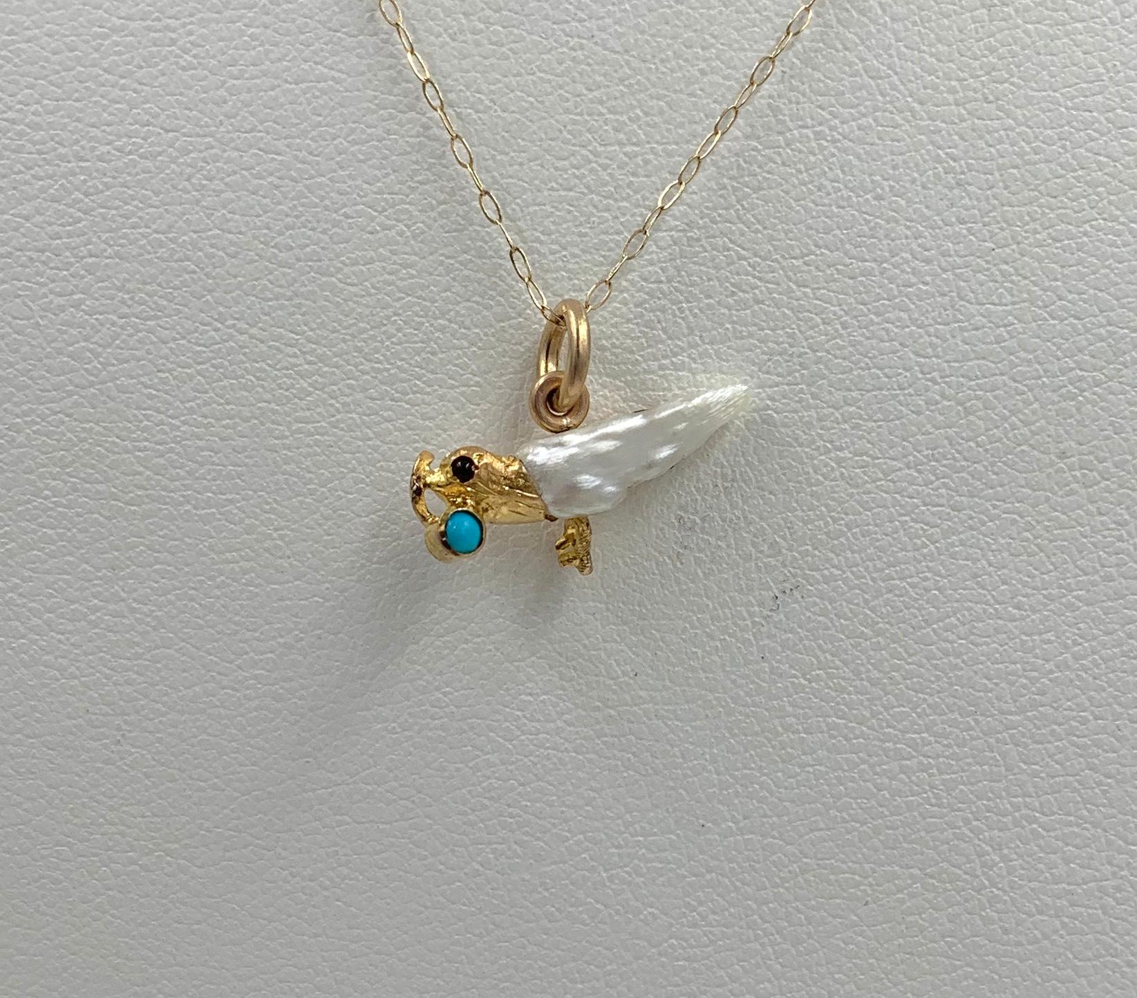 A stunning romantic antique Victorian - Edwardian Pendant or Charm in the form of a flying Bird carrying a Persian Turquoise and set with a Ruby eye and Baroque Pearl Wings.  The pendant has elements of the Victorian as well as the Edwardian