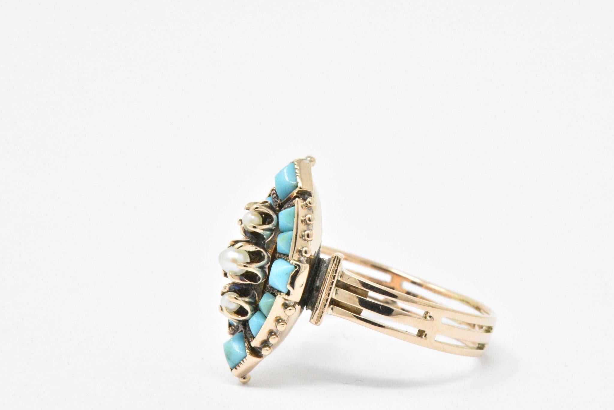 Navette form set with calibre cut turquoise and centering three seed pearls

Delightful gold beading detail and pierced shank make this a very unique ring

Ring Size: 5 1/2

The top of the ring measures 18.2 mm wide and the ring sits 6.5 mm