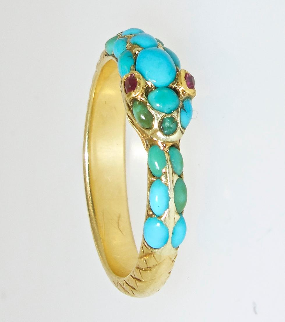 The serpent in jewelry signifies eternity and has remained a popular motif.  The Persian turquoise are natural and the eyes are small rubies.  This fine antique ring is 18K yellow gold and a size 6.5.  It can easily be sized.  Probably English, 