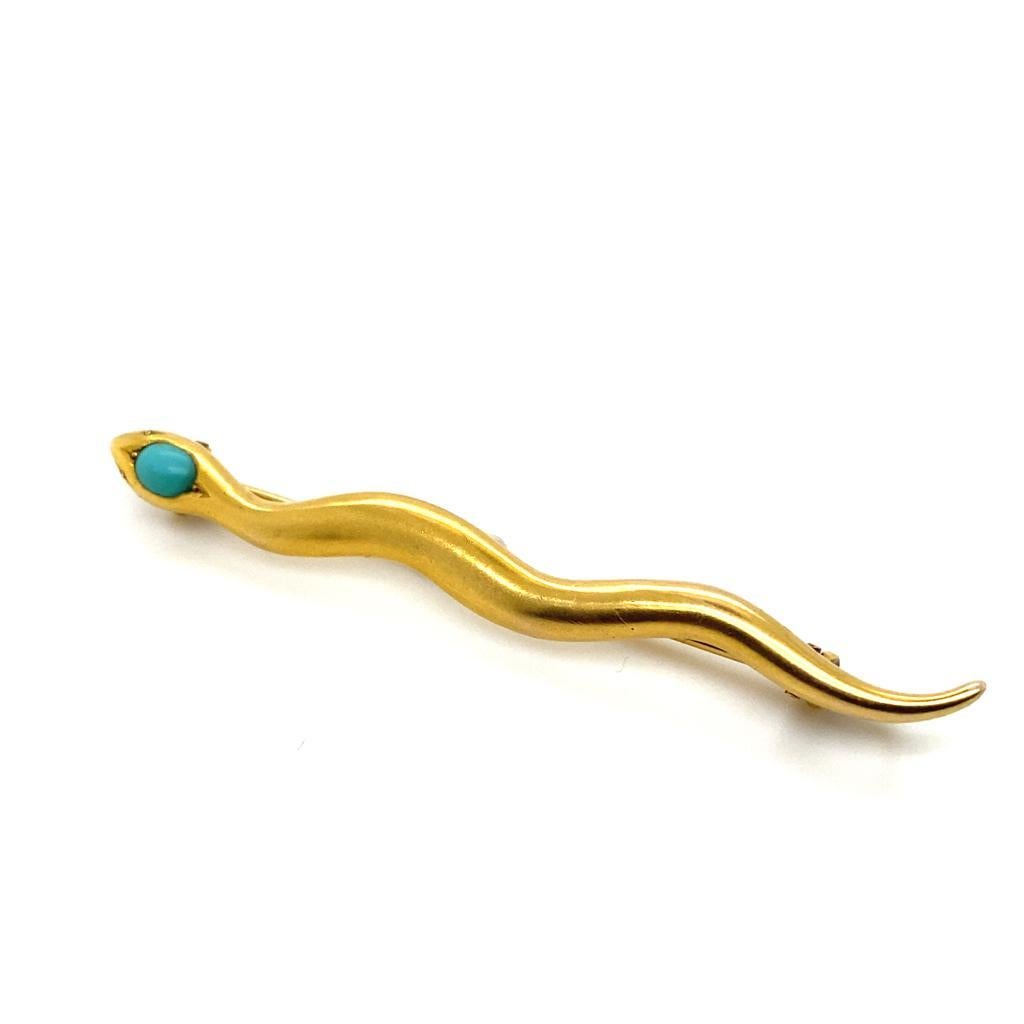 A Victorian turquoise snake brooch 18 karat yellow gold.

This charming brooch is crafted in plain polished gold and set to its eye with a single cabochon turquoise.

There is an additional safety bar fitting to its reverse - meaning that that this