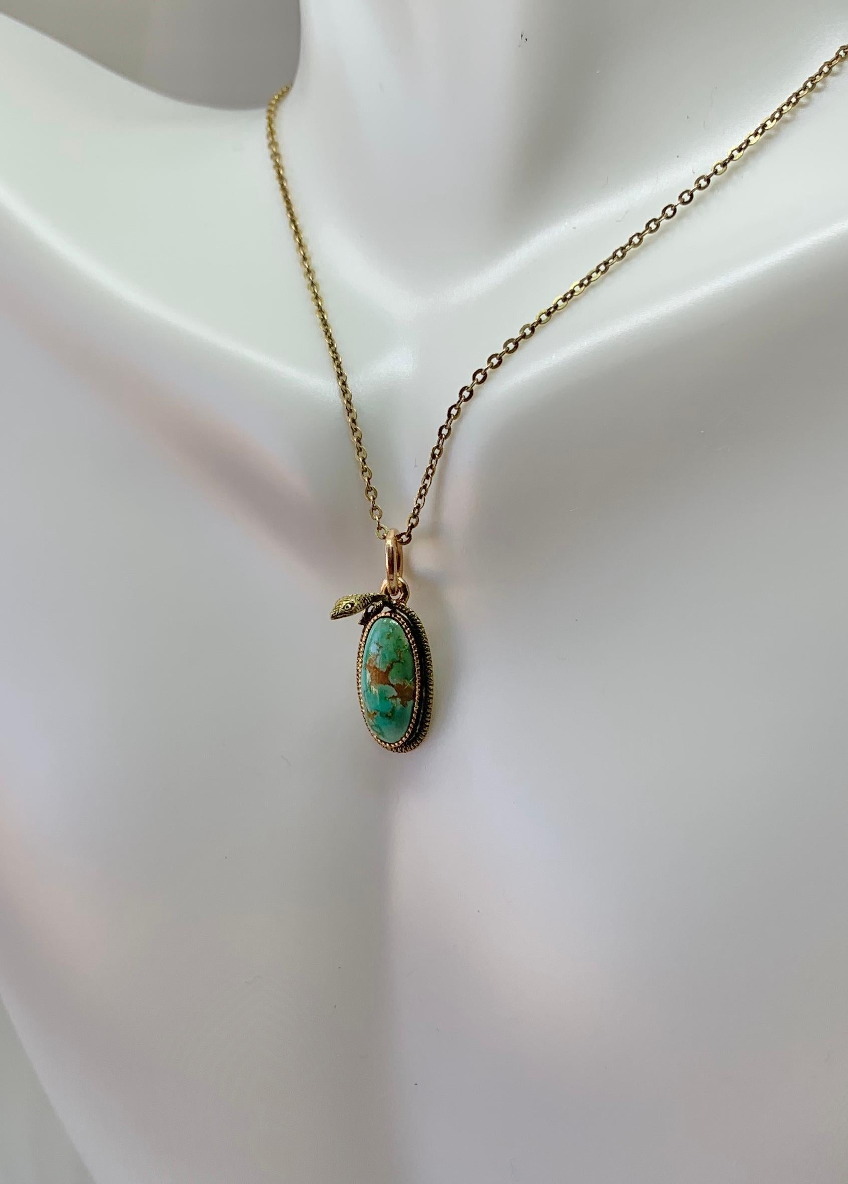 This is a very rare antique Victorian Turquoise Snake Pendant Necklace depicting a snake or serpent wrapped around a Turquoise egg or globe.  The snake is beautifully created with stunning three dimensional design in 14 Karat yellow gold by the