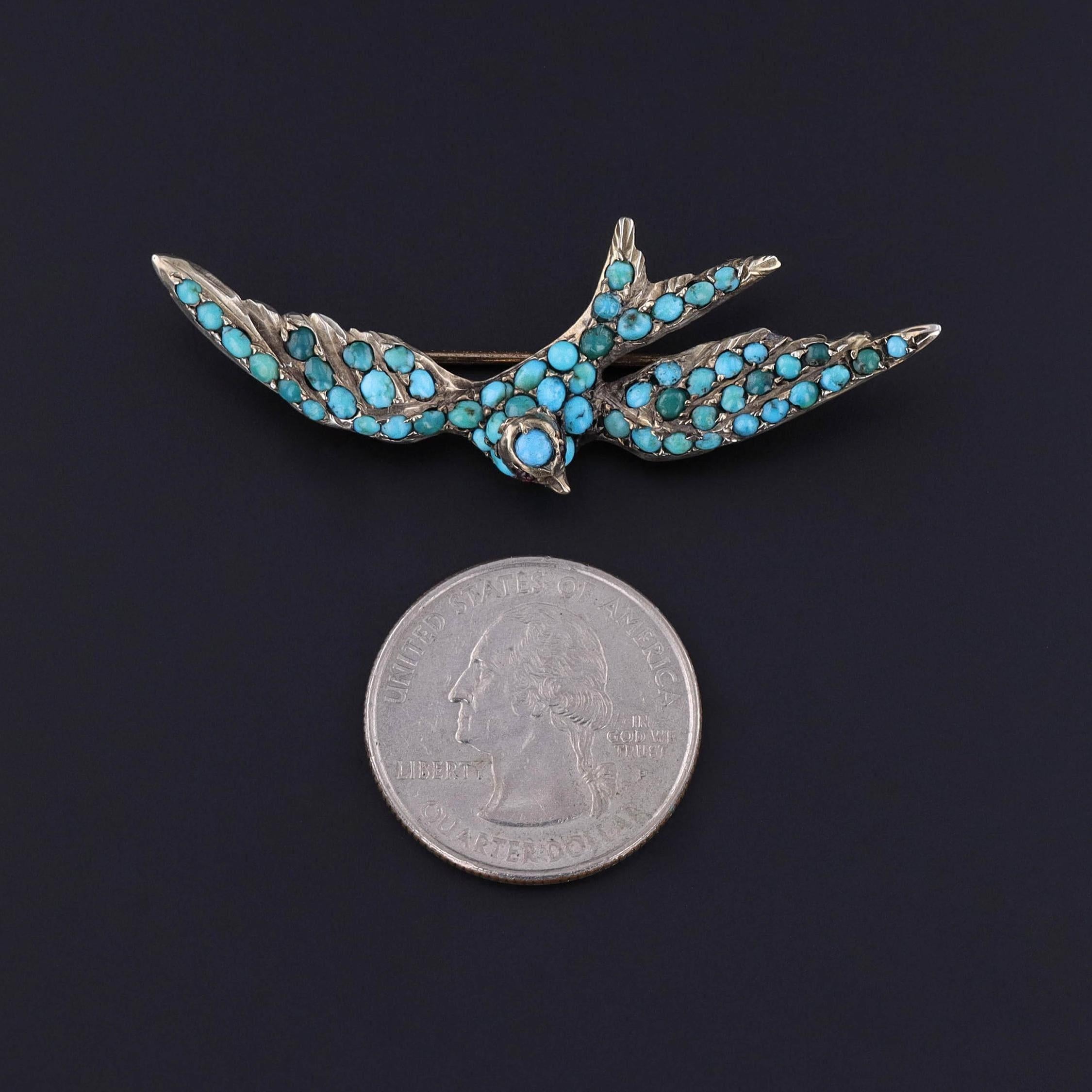 Antique Turquoise Bird Brooch: This Victorian era brooch (circa 1880) features a swallow adorned with turquoise cabochons and two ruby eyes. The swallow is 800 silver - a slightly lower silver content than sterling silver which is 925/1000 parts
