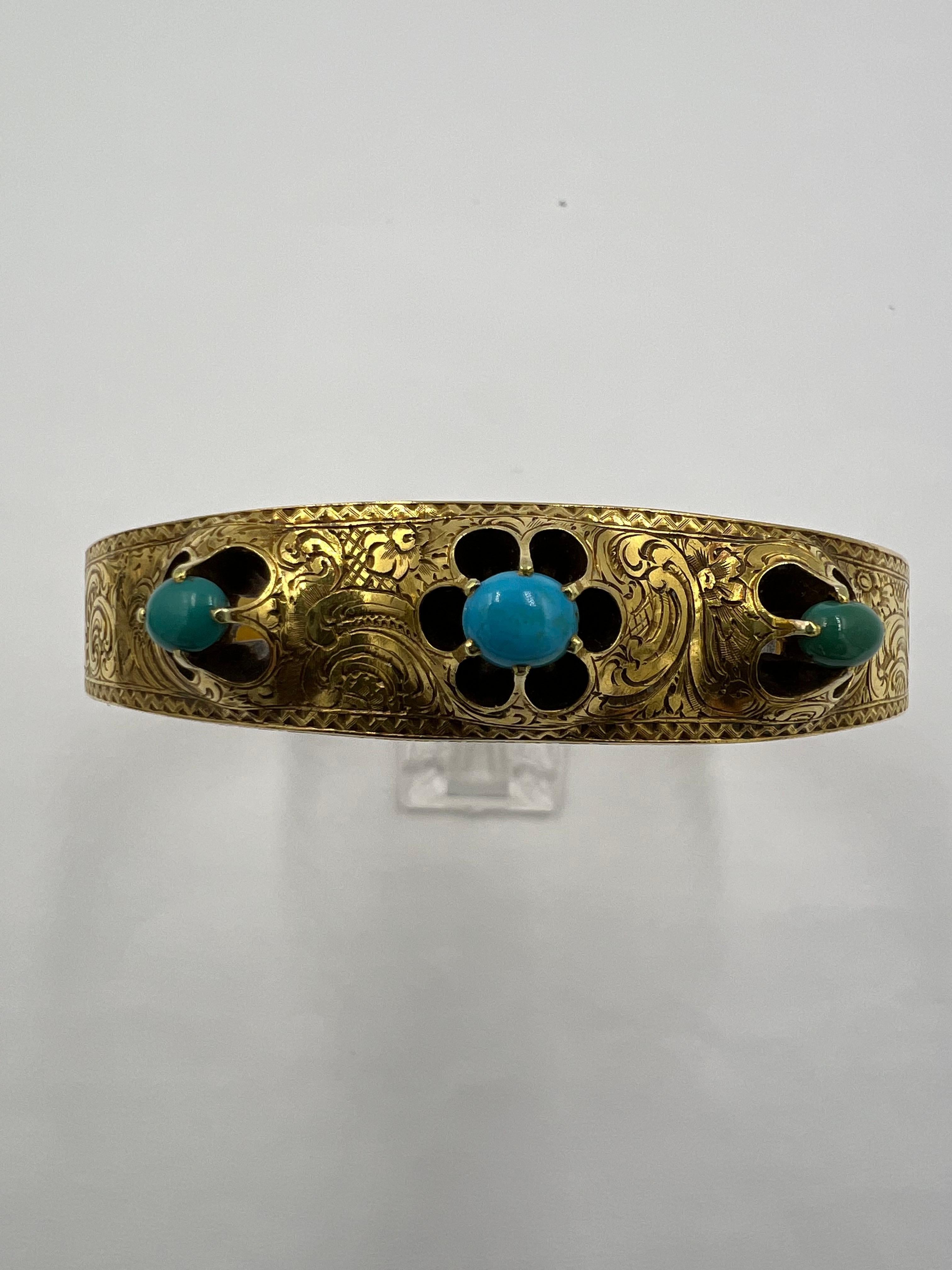 Victorian Turquoise yellow gold hand chased bangle bracelet, circa 1890.
This Victorian Turquoise Yellow Gold Hand Chased Bangle Bracelet is a stunning piece of jewelry that is sure to turn heads and make a statement. Crafted with intricate
