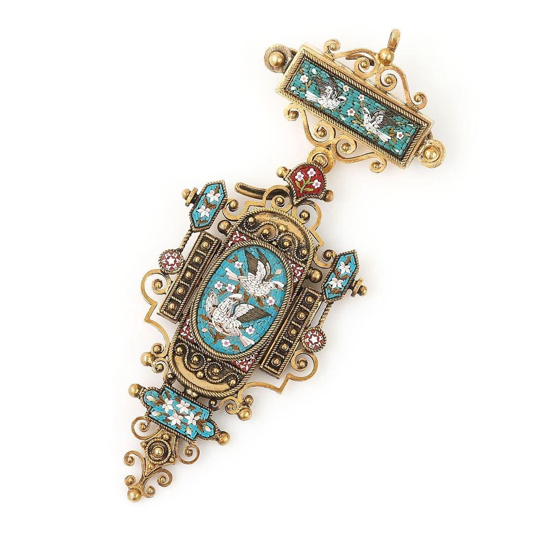 A truly unique and wonderful antique Victorian micromosaic pendant and brooch depicting at its centre two white (turtle) doves. The piece which dates to the middle of the 19th century is masterfully crafted from gilt metal and is highly ornate with