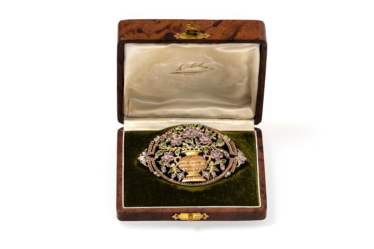 An unusual and finely detailed Nurses belt buckle dating from the Victorian era. Typical of the period it is made in two coloured gilt and beautifully decorated with white, pink and green paste set flowers. Fitted in its original box. 
In excellent