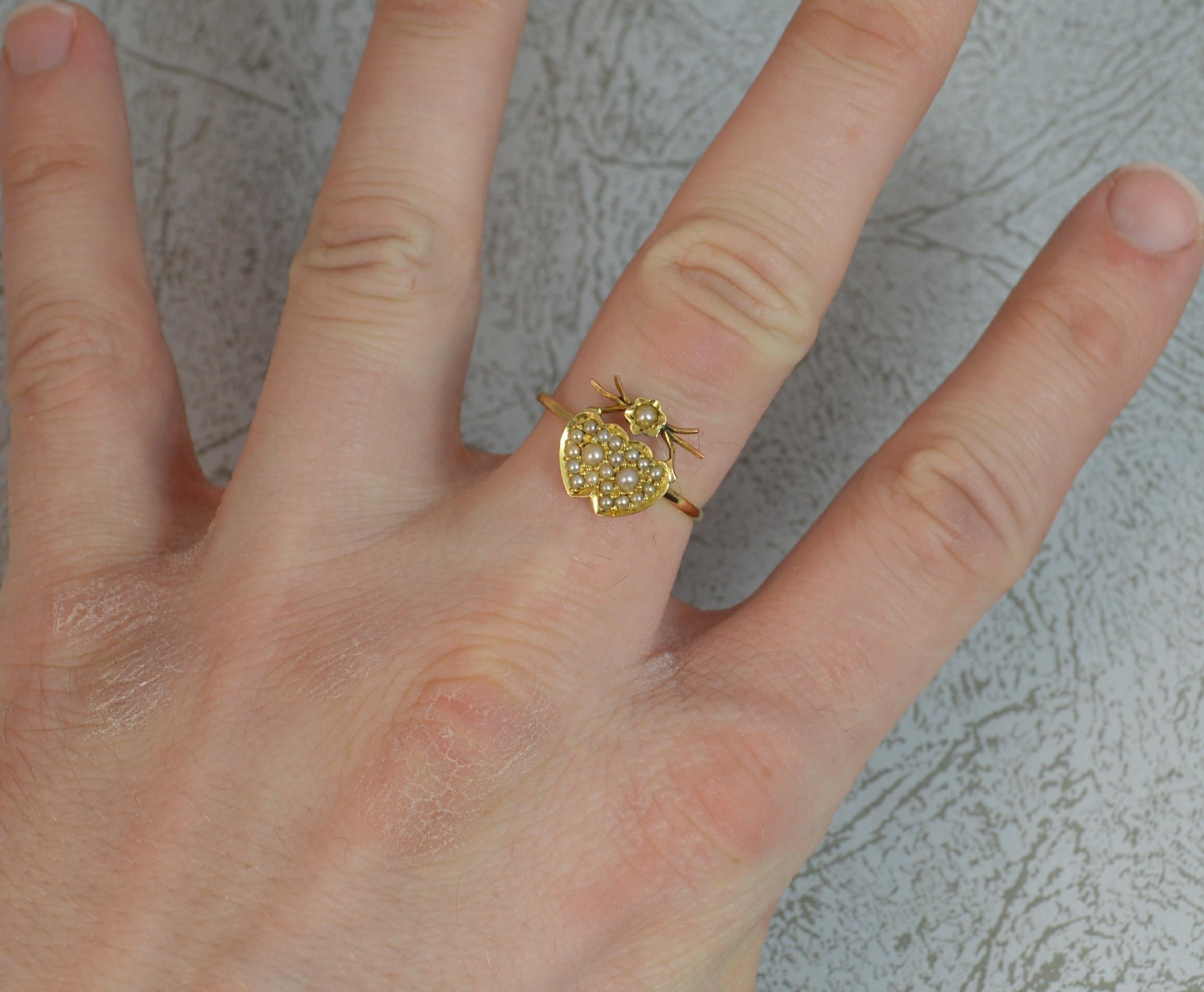 A beautiful Victorian era double cluster ring.
SIZE ; P UK, 7 3/4 US
Solid yellow gold example. 
Designed with two hearts entwined and encrusted with seed pearls. 
11mm x 12mm head. Simple shank.
CONDITION ; Very good for age. Clean and solid band.