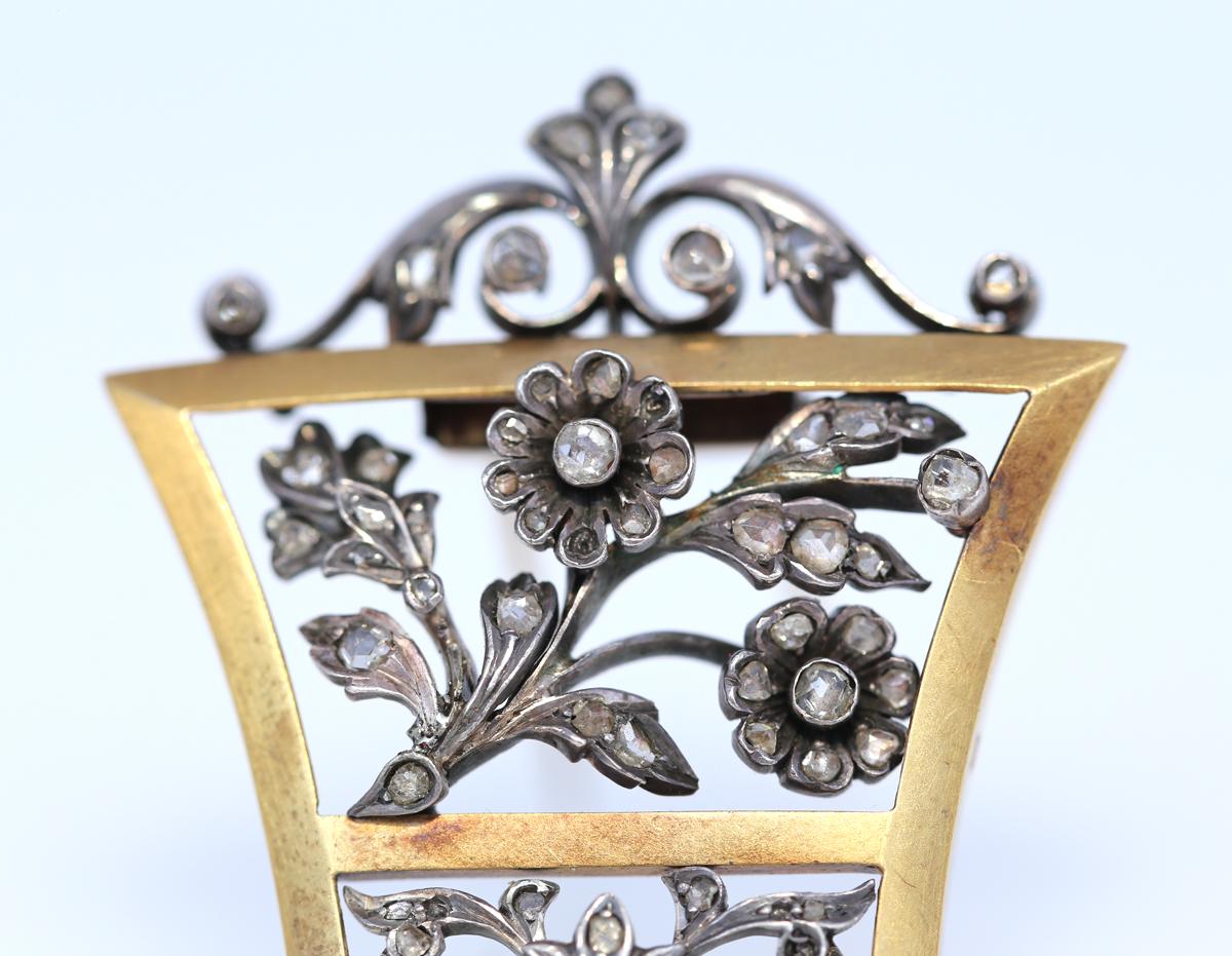 Unisex Victorian Brooch with Old-cut Diamonds. Gold & Silver. 1905. Delicate and fine work of the jeweler depicting flowers and natural ornament. The composition amazingly suggests that the natural motive shown in Silver has grown into a Gold frame.