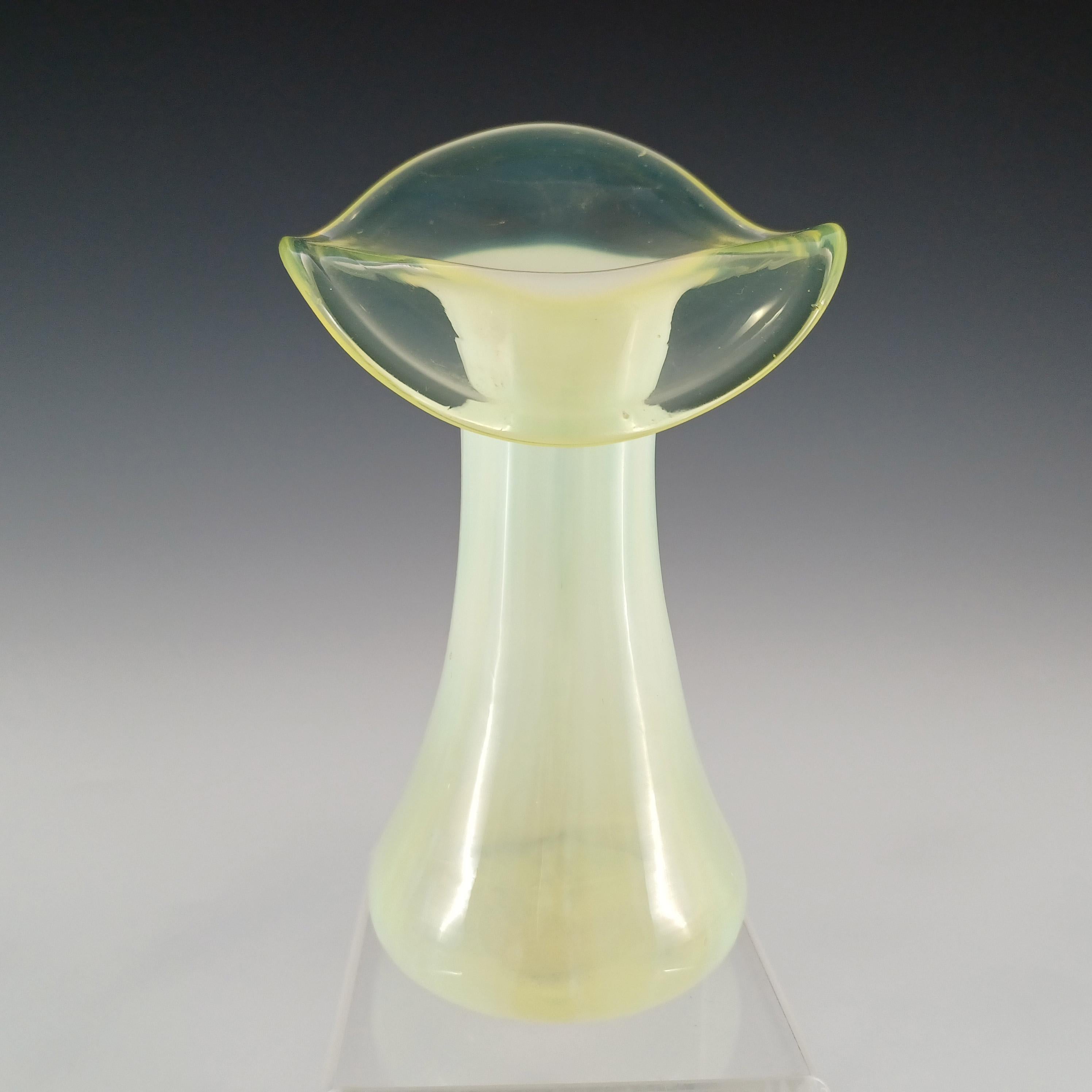 A wonderful Victorian yellow green vaseline glass jack-in-the-pulpit vase, with vertical striped opalescent body, circa 1890's. Made in uranium glass, which glows bright green in UV light.

Please note: the plastic stand is for display purposes only
