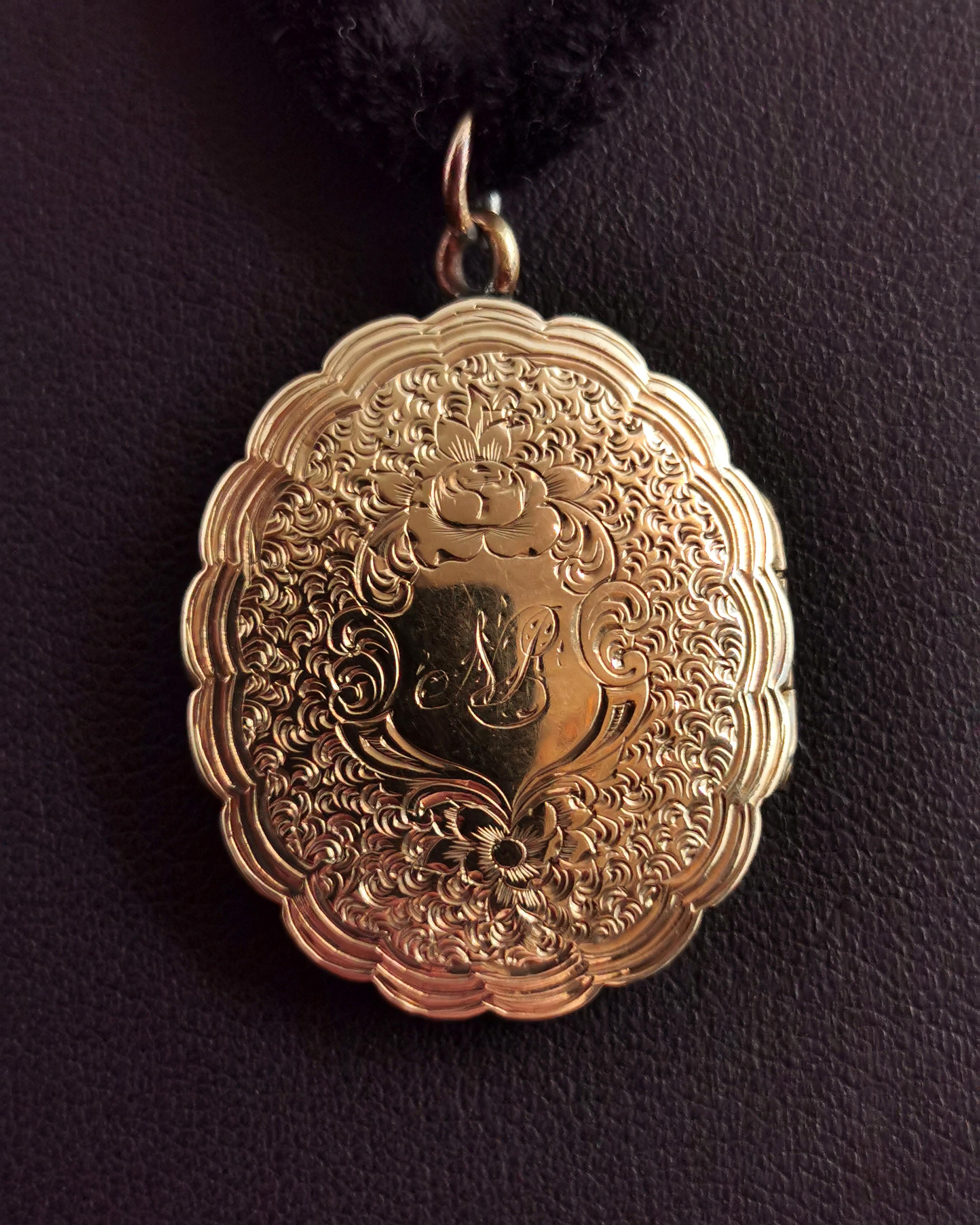 A beautiful antique, Victorian era 9kt gold front and back locket on a velvet choker necklace.

The locket is oval shaped with a scalloped edge and has an engraved front and back.

It has a floral style engraving and the front is monogrammed N P in