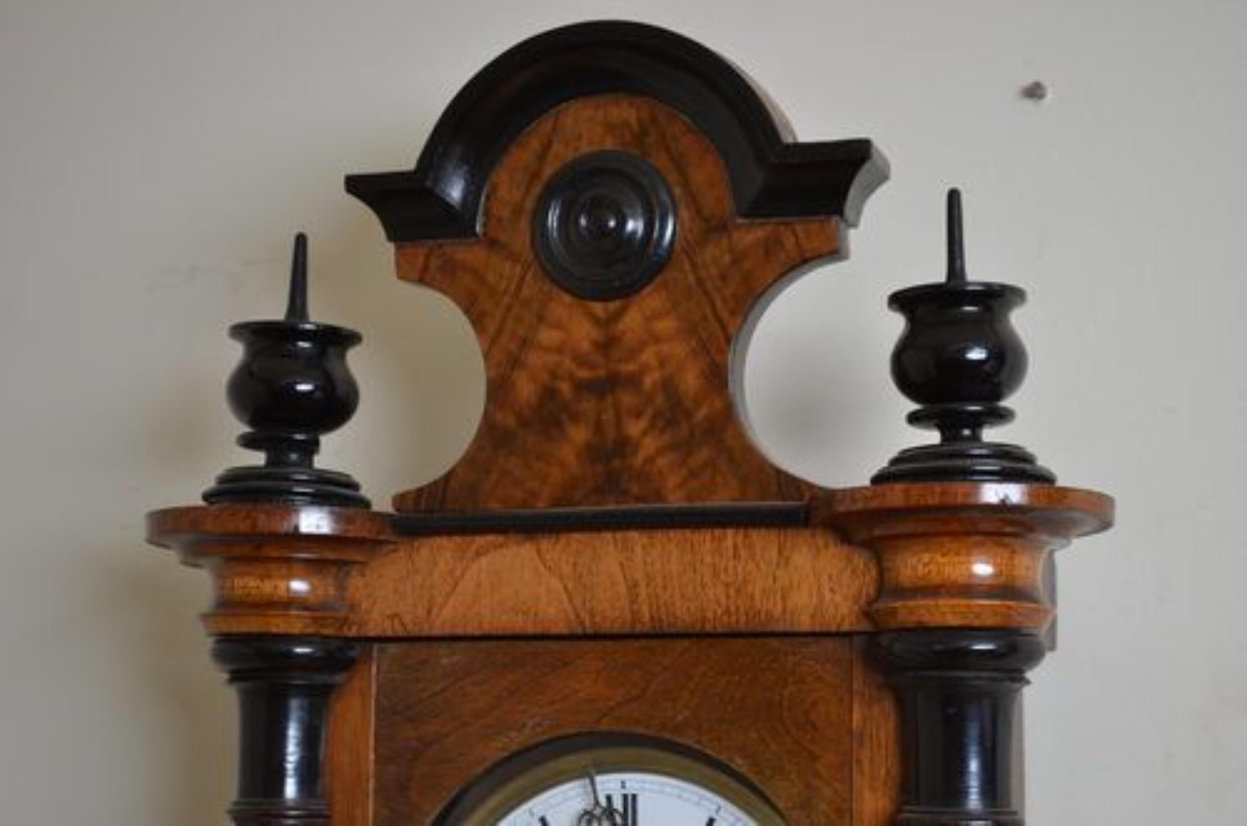SN2531 fine quality and very attractive, Victorian, walnut Vienna clock of unusual small proportions, having ebonised finials and reeded columns to sides, in fantastic original condition with some repolishing. The movement has been cleaned and