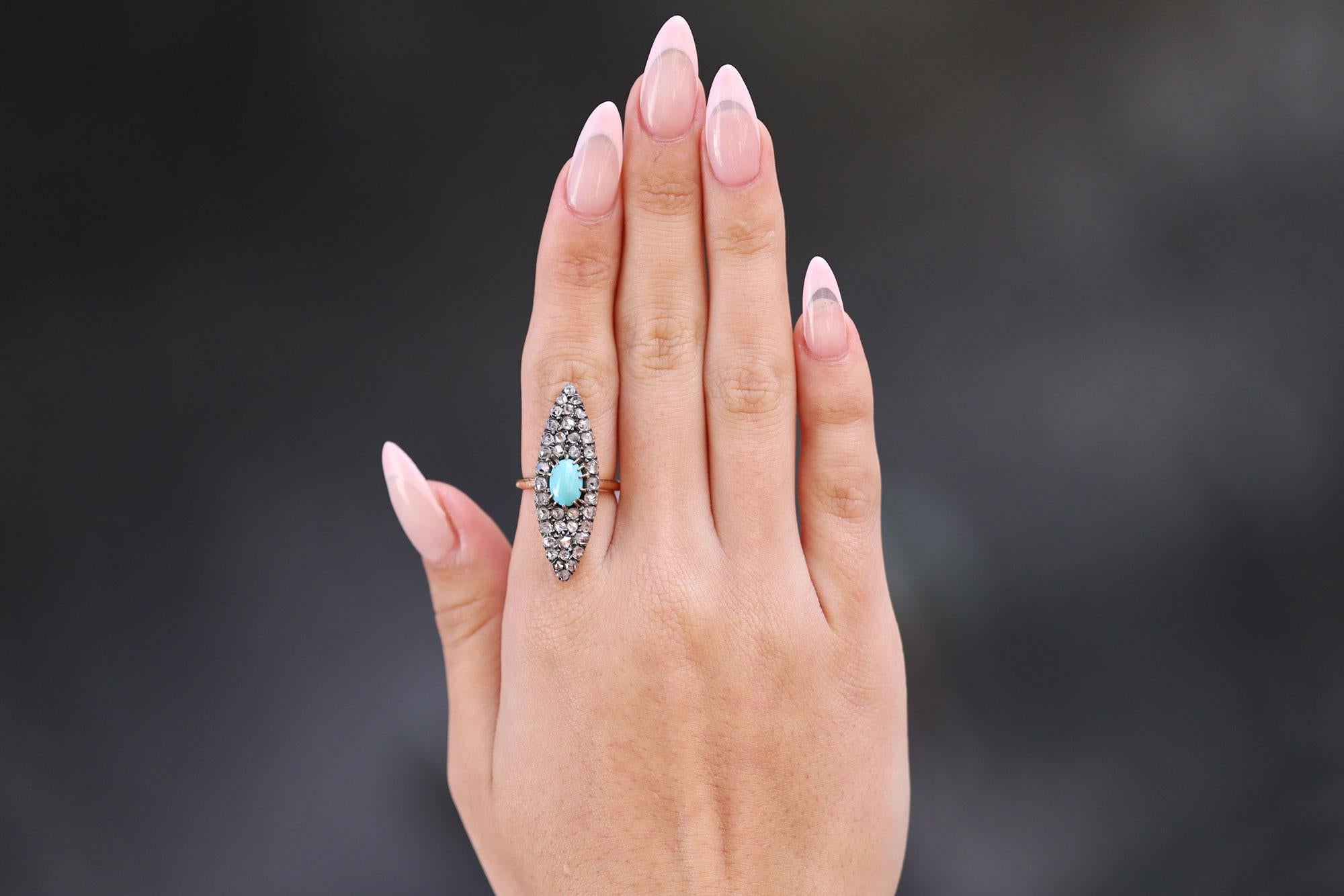 A vivacious Victorian vintage diamond and turquoise navette ring that is long, sleek and slender. This late 19th century stunner is loaded with charm, centered by a striking Persian turquoise of a perfect color and surrounded by 40 twinkling rose