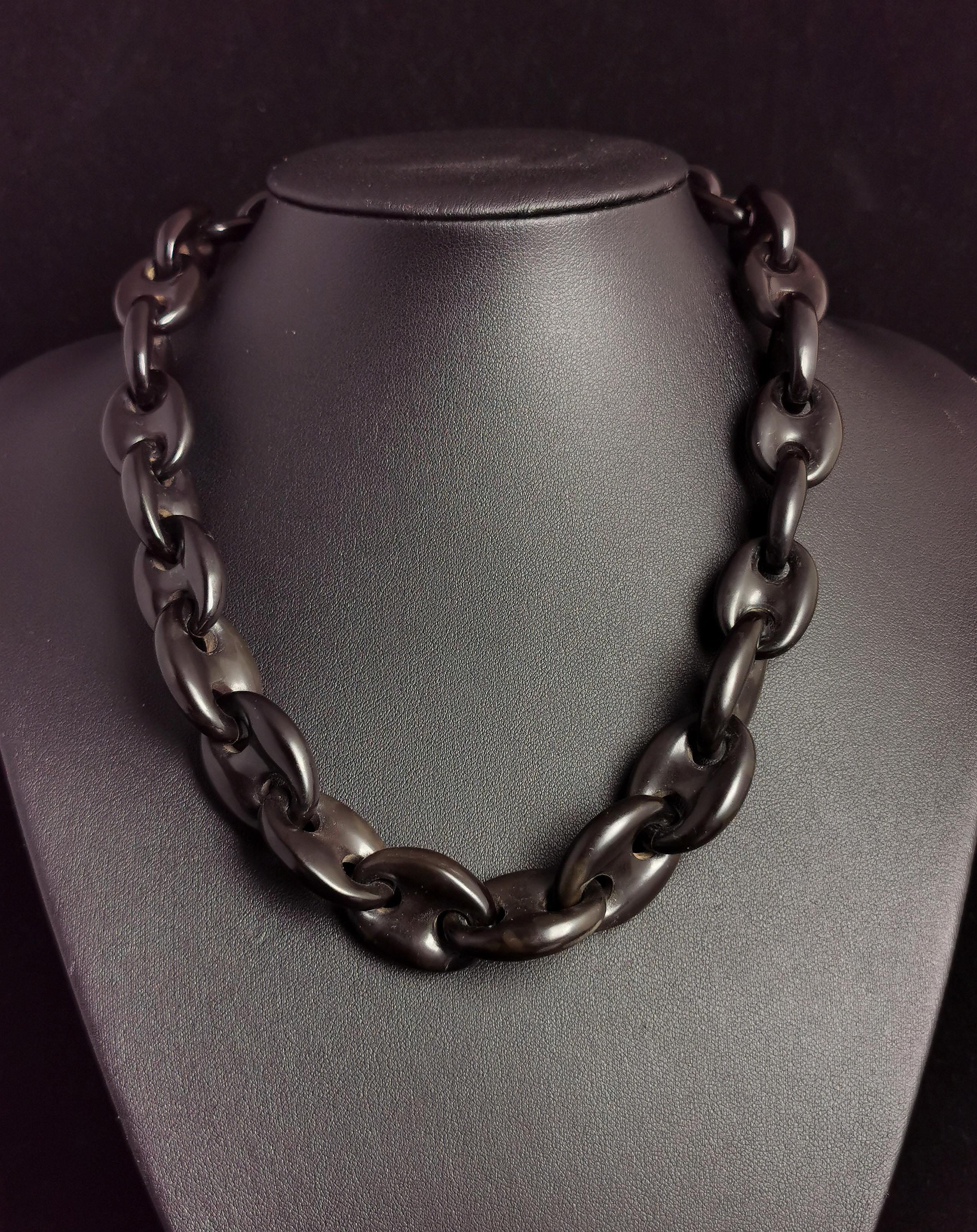 A beautiful antique Victorian mourning necklace.

It is a large chunky mariner link chain necklace made from vulcanite.

The necklace fastens with a black lacquered metal spring ring.

The mariner link is a nice find on a vulcanite piece and more