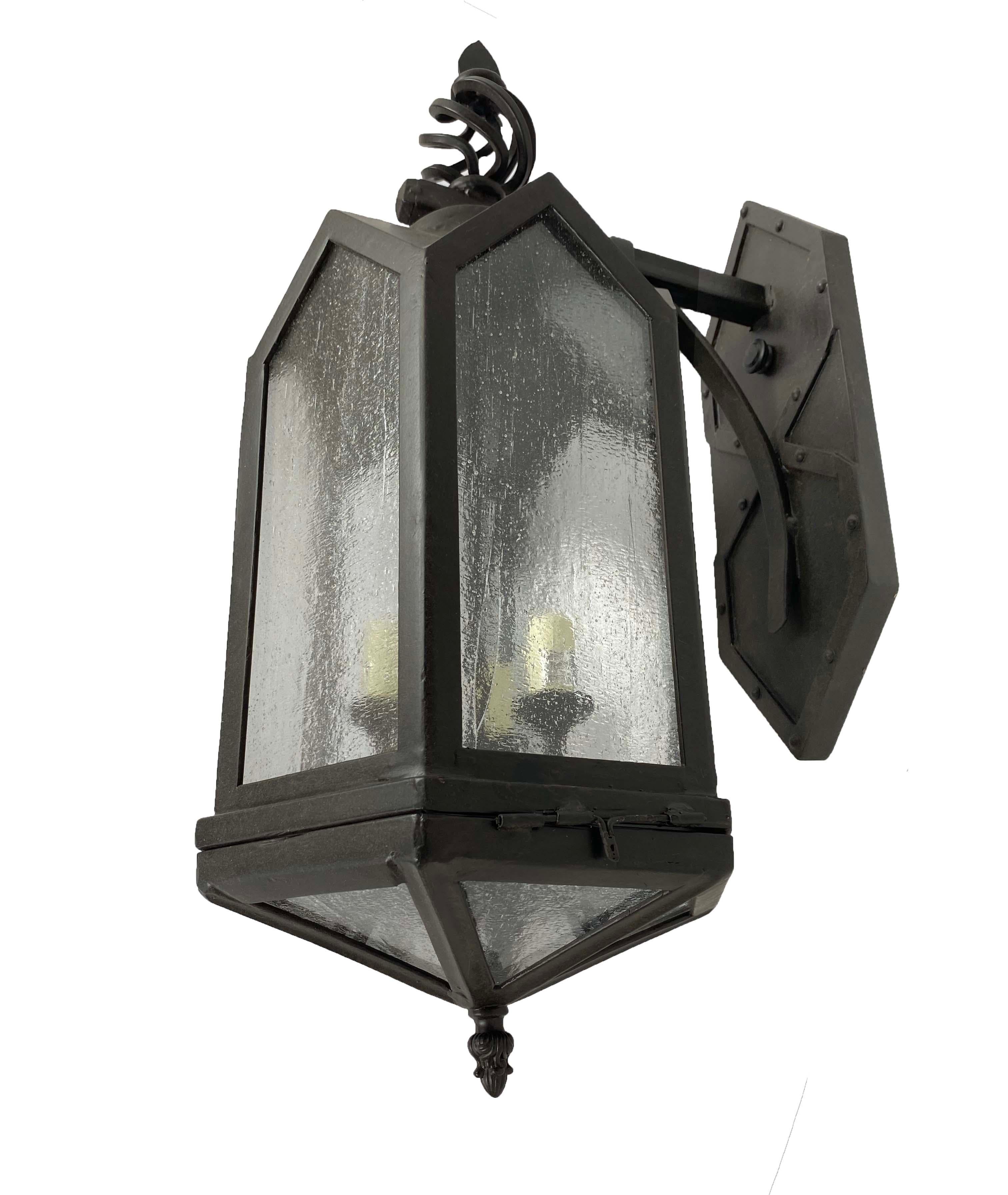 This unusual wrought iron lantern was used on a western movie set. Highly textured glass and pyramid bottom add to its exotic nature. This is a one of a kind lantern with curb appeal.