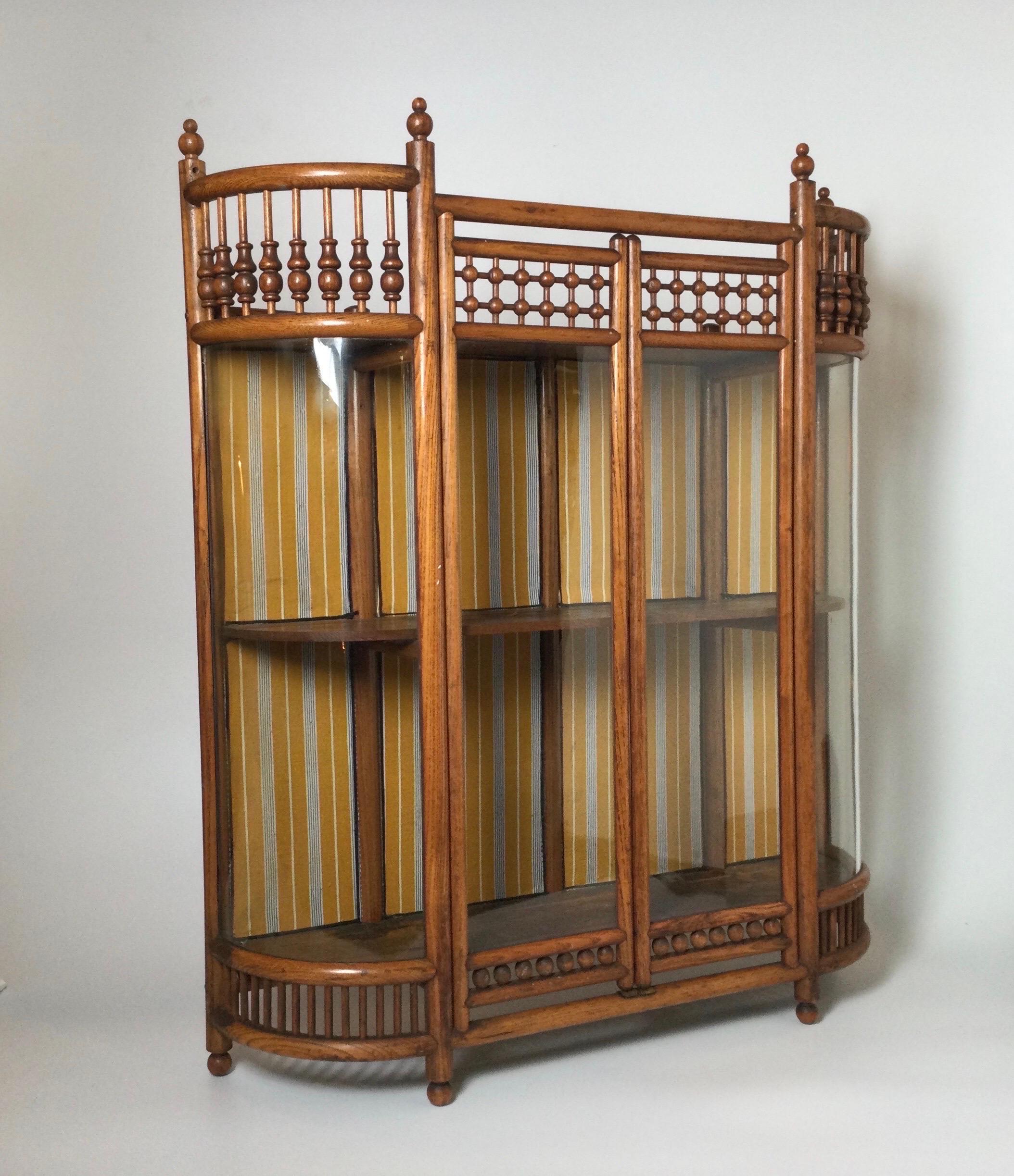 Wonderful well made hanging wall cabinet with ball and stick design with glass front and sides. The two front doors with glass curved side panels with shelf. The back is lines in a vibrant stipe which can be changed easily.