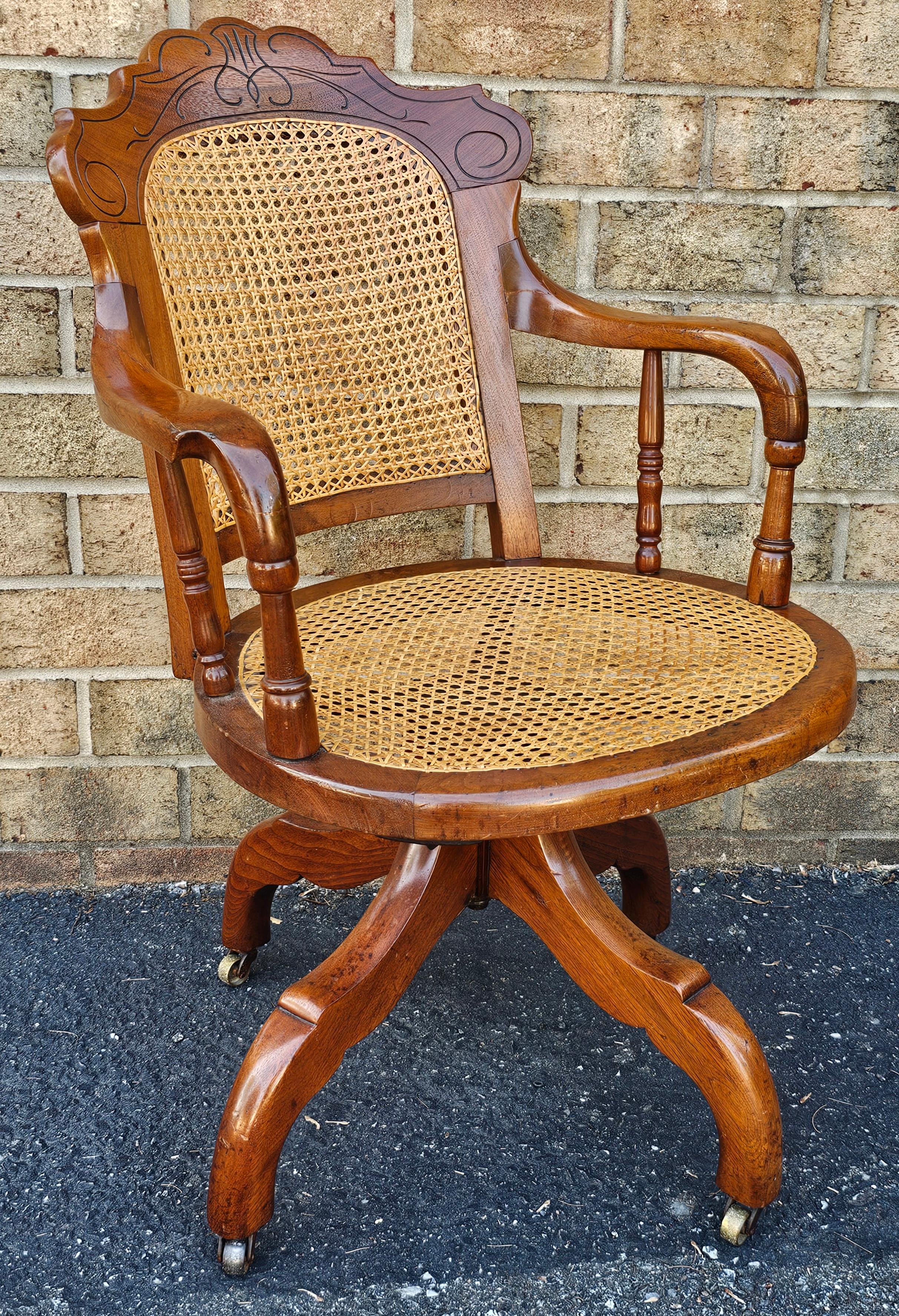 American Victorian Walnut and Caned Seat and Back Rolling Office Chair For Sale