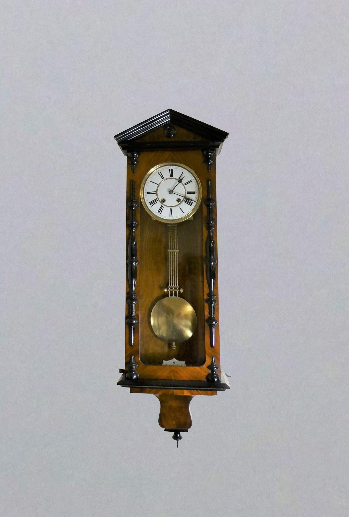 Victorian Walnut and Ebony Vienna ‘Regulator’ Wall Clock
 
Victorian Vienna ‘Regulator’ wall clock housed in a walnut case with ebony mouldings, architectural pediment and sweeping base with ebonised finial.  Original enamel beat plaque to the