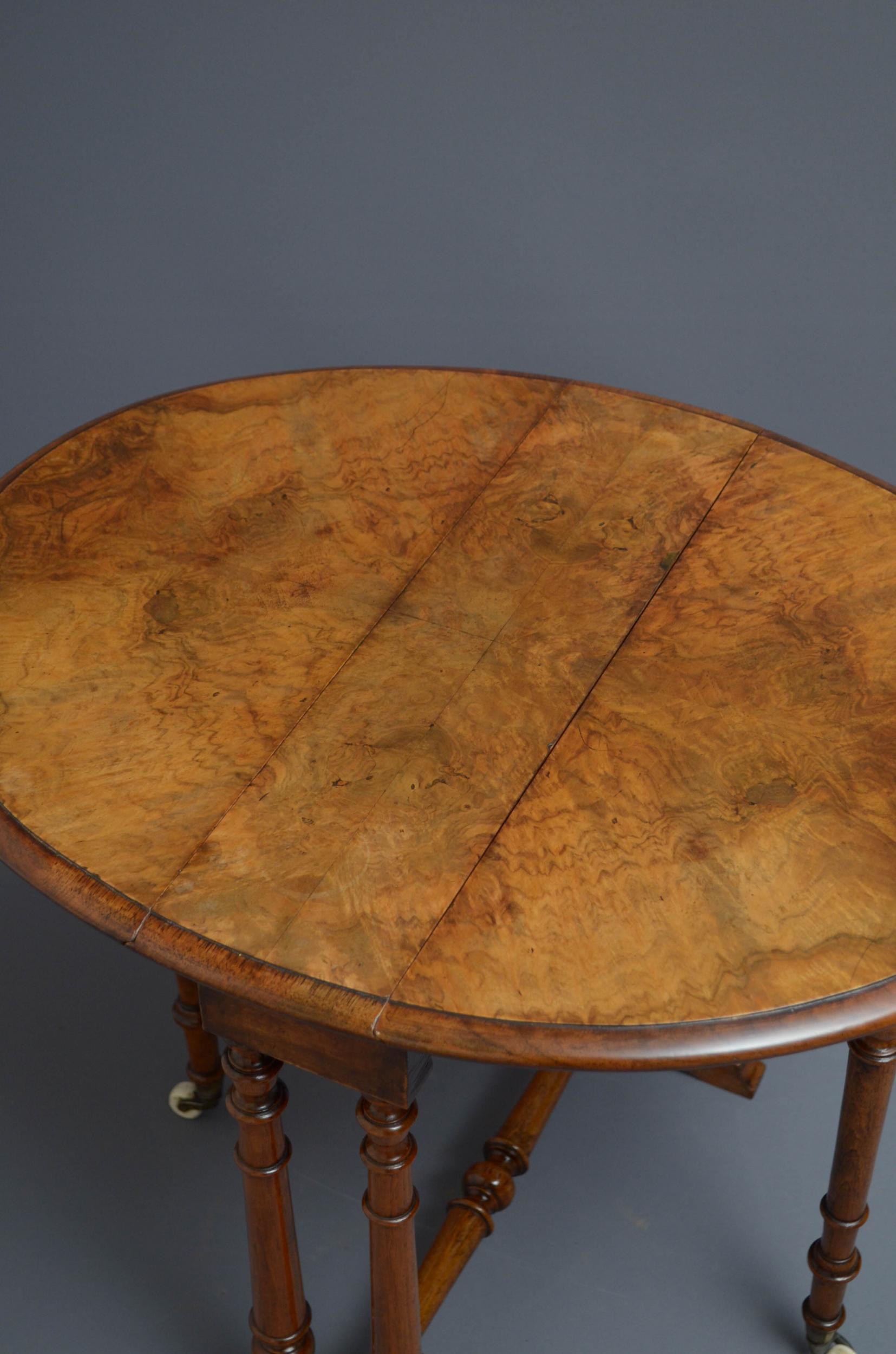 Sn5006 small Victorian, burr walnut Sutherland table of oval design, having figured walnut drop leaf top with moulded edge, standing turned supports terminating in outswept feet, all united by turned stretcher. c1870

Measures: H21