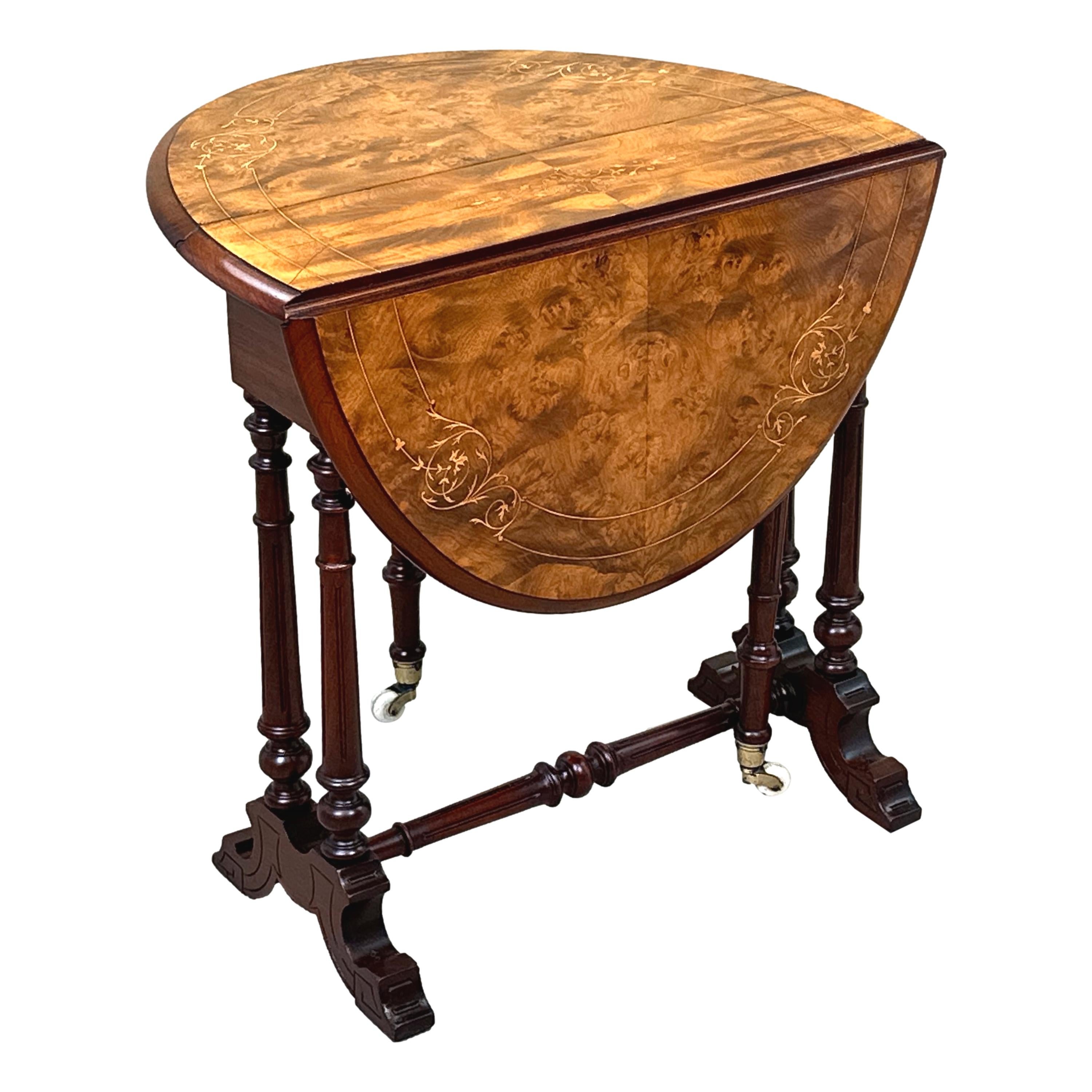 A Very Good Quality Late 19th Century, Victorian Period, Figured Walnut Baby Sutherland Table, Having Attractive Marquetry Inlaid Decoration To Well Figured Oval Drop Flap Top, Raised On Elegant Turned Eupright Supports With Original Ceramic