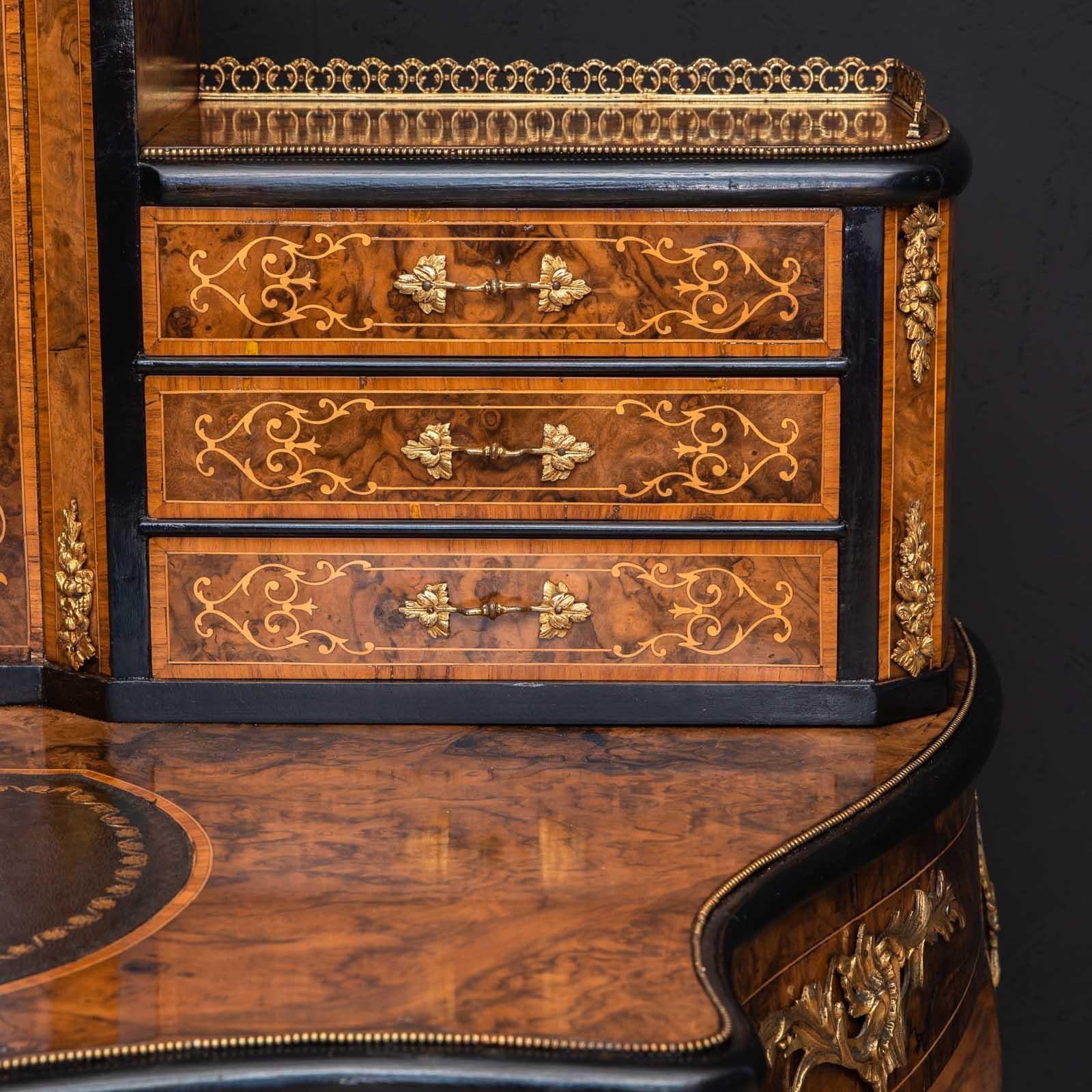 A beautiful walnut ladies writing desk from the mid Victorian period. Very shapely and decorative, with ormolu mounts and mouldings throughout combined with boxwood inlays and stringing. Recently repolished and with a new leather writing surface,