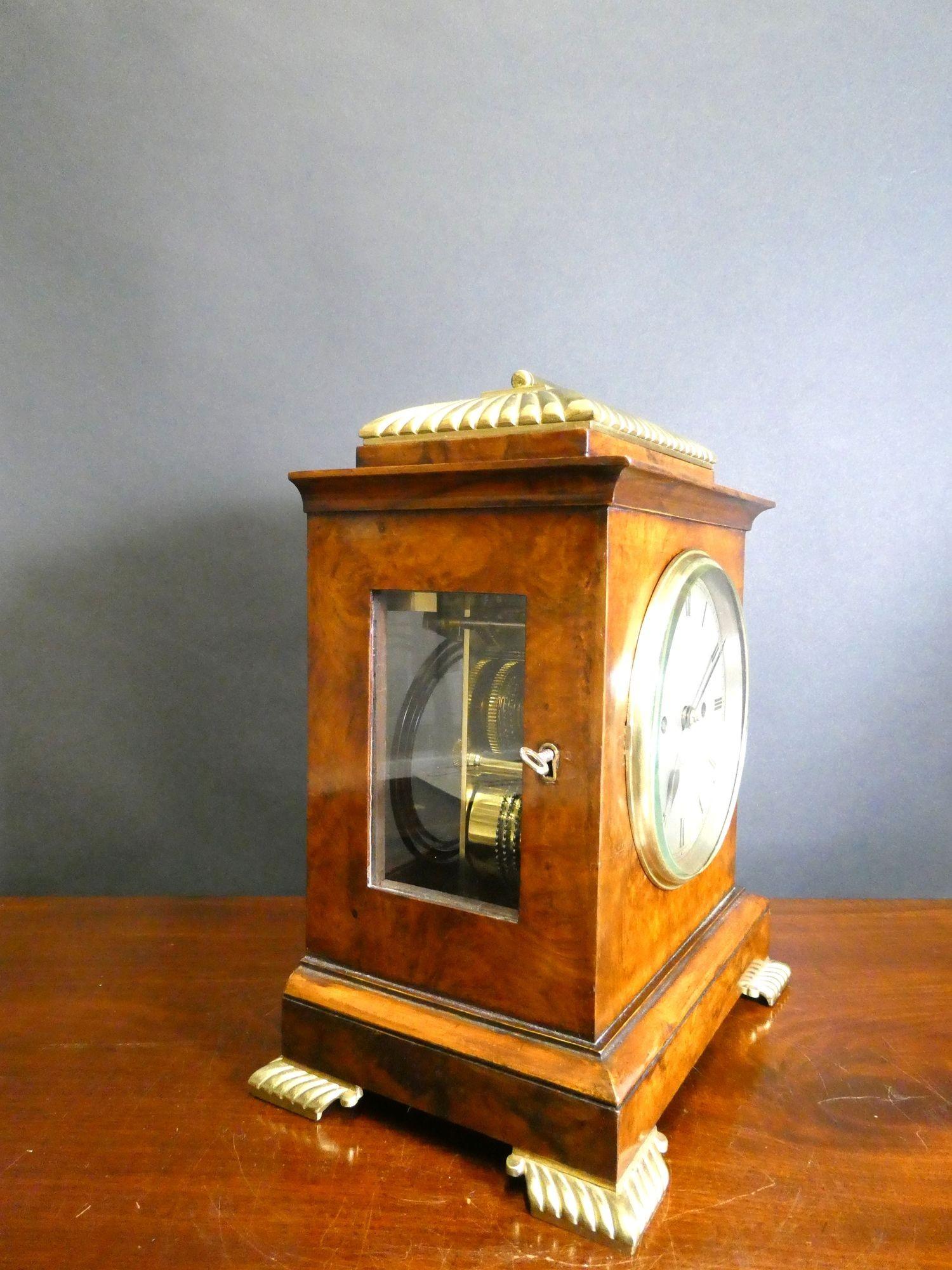 Victorian Walnut Bracket Clock by Barraud & Lund, Cornhill, London

Victorian bracket clock housed in a finely figured walnut case with stepped pediment surmounted by ribbed brass decoration. Raised moulded plinth reasting on brass ribbed bracket