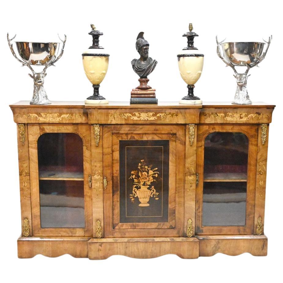 High end Victorian sideboard of breakfront form
Hand crafted from walnut with intricate inlay work including floral motifs and a central panel with a floral spray urn
Ormolu fixtures are original
Stunning patina to the walnut and we date this to
