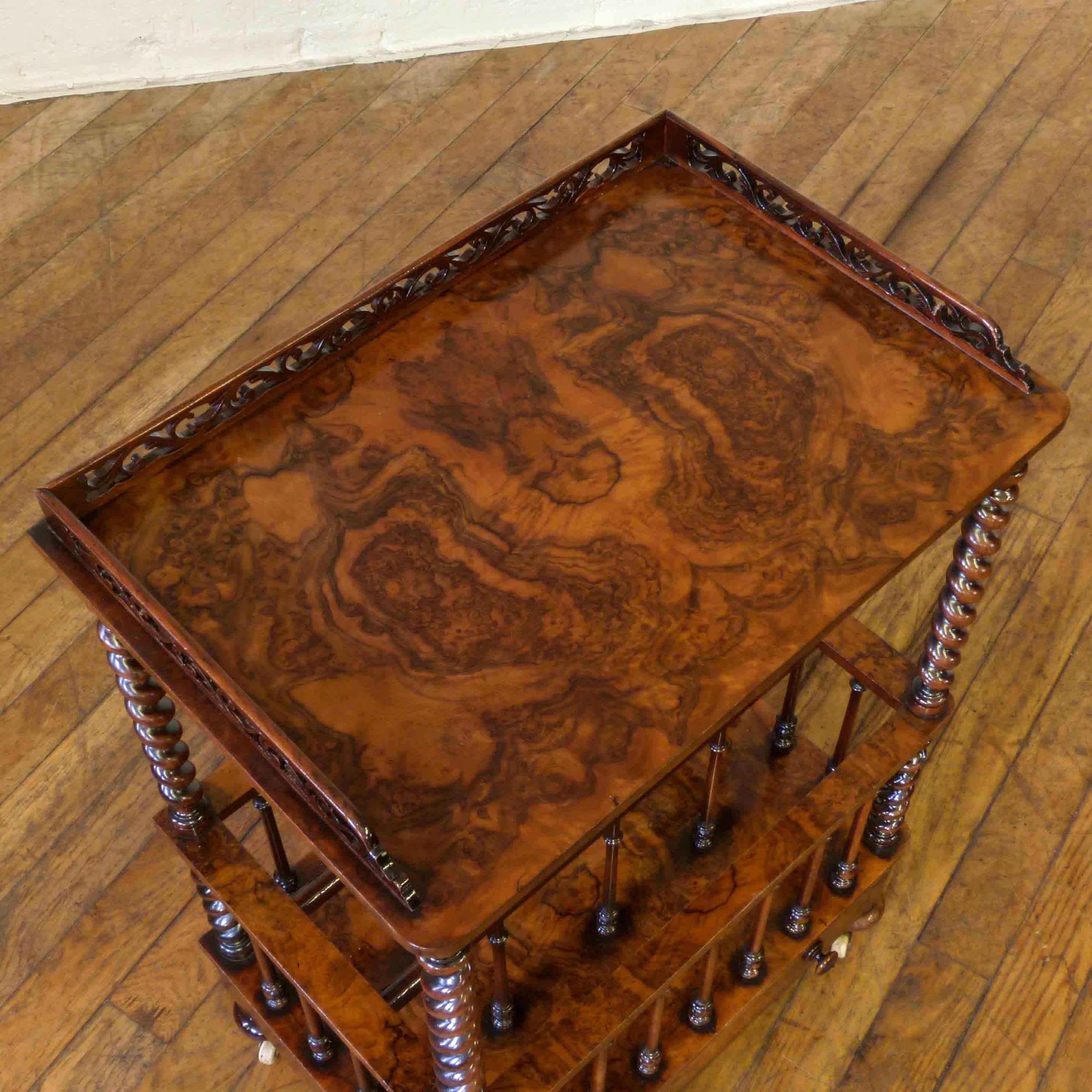 A good mid Victorian burr walnut Canterbury with upper galleried shelf and lower drawer to the base. Complete with the original turned legs and castors this piece is showing no damage and the overall colour and condition is excellent. A great piece