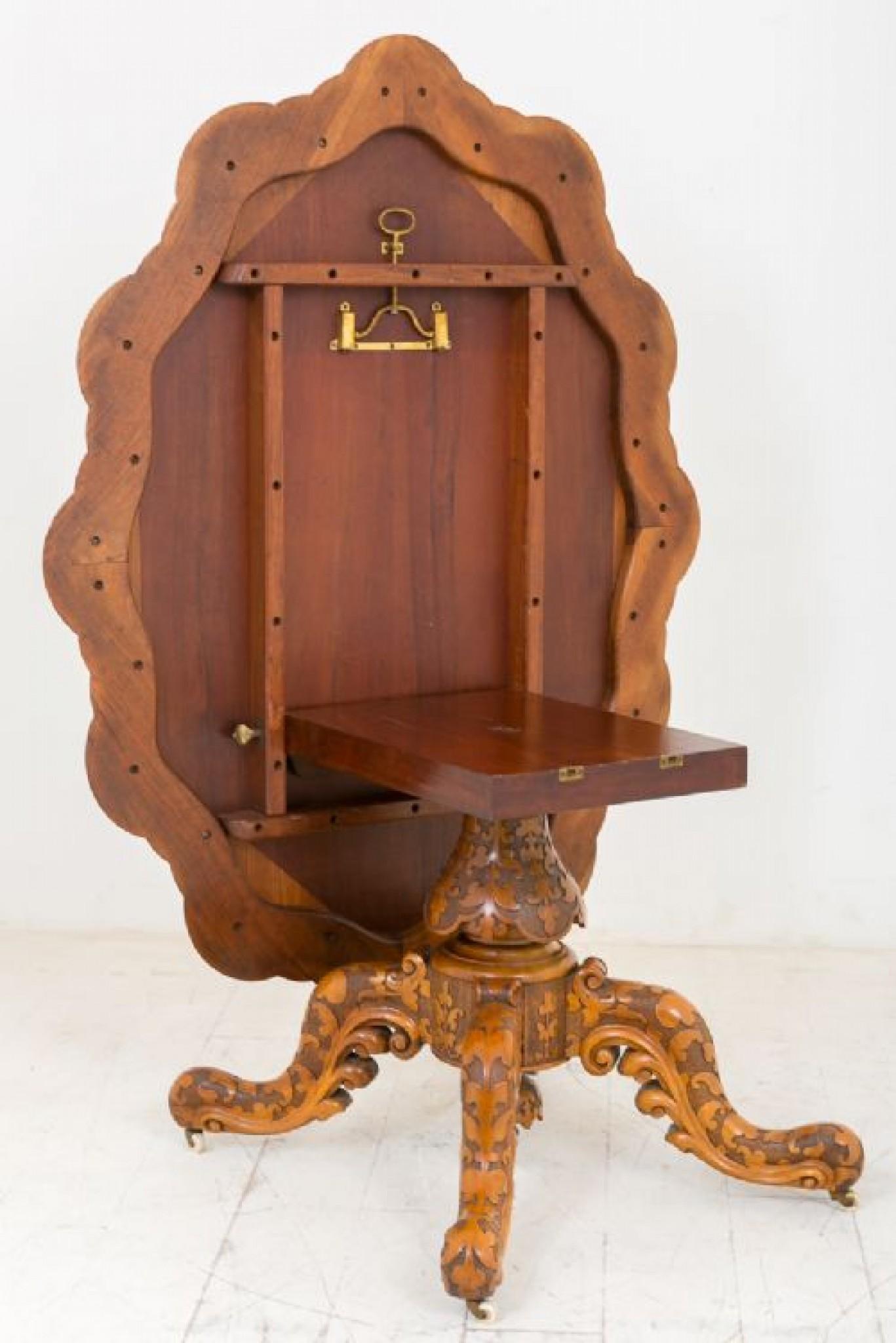 Superb Quality Walnut Centre Table, standing on a heavily carved Quadra Foil base with original porcelain castors.
The supporting column also heavily carved.
circa 1860
The Burr Walnut shaped top featuring carved double mouldings.This table tips