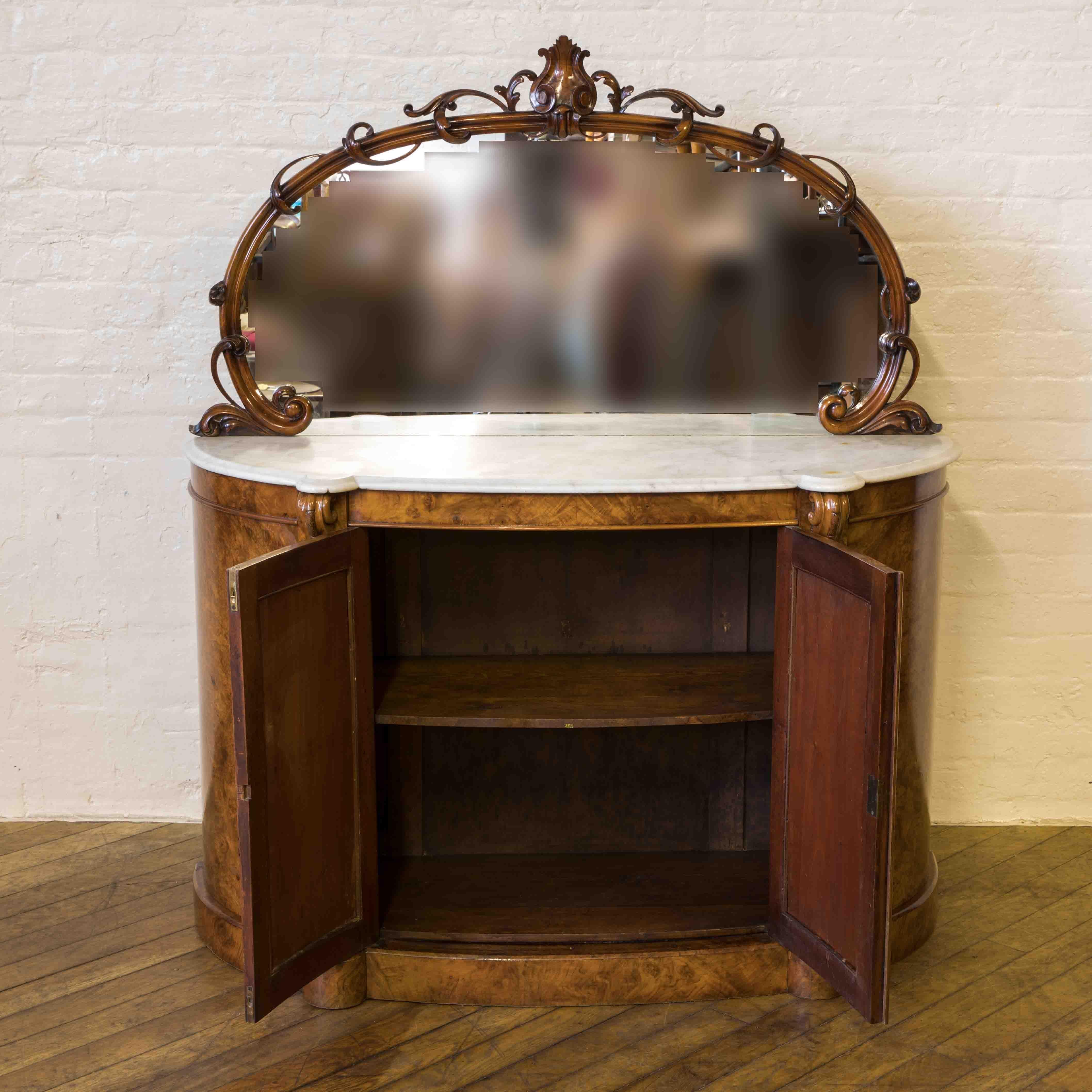 A beautiful Victorian burr walnut chiffonier with wonderful fretted doors to the base complete with working lock and key. The original marble top has no cracks or chips and the intricate craved foliate frame to the mirror back is also in super