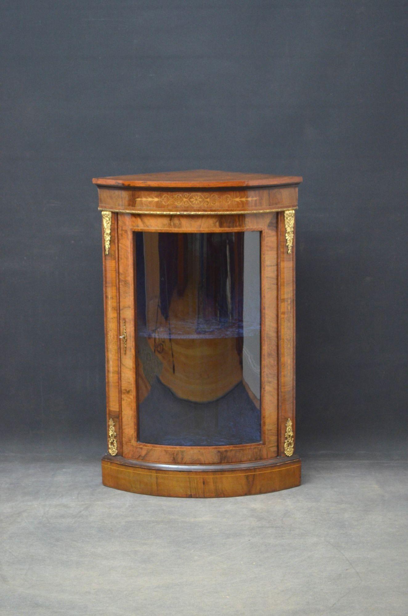 Sn4727 Unusual Victorian figured walnut, bowfronted corner cabinet, having string inlaid top above string inlaid frieze and glazed door fitted with working lock and enclosing relined interior, all flanked by inlaid pilaster and ormolu decoration,