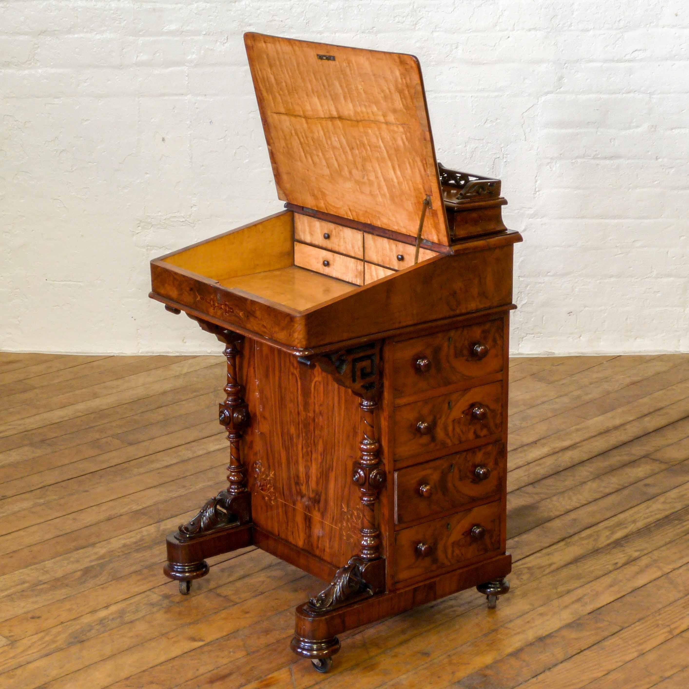 An attractive inlaid burr walnut davenport from the Victorian period. With dummy drawers to one side and the real working ones to the other(as is the case with most davenports). The maple interior has two drawers and the upper hinged lid has a