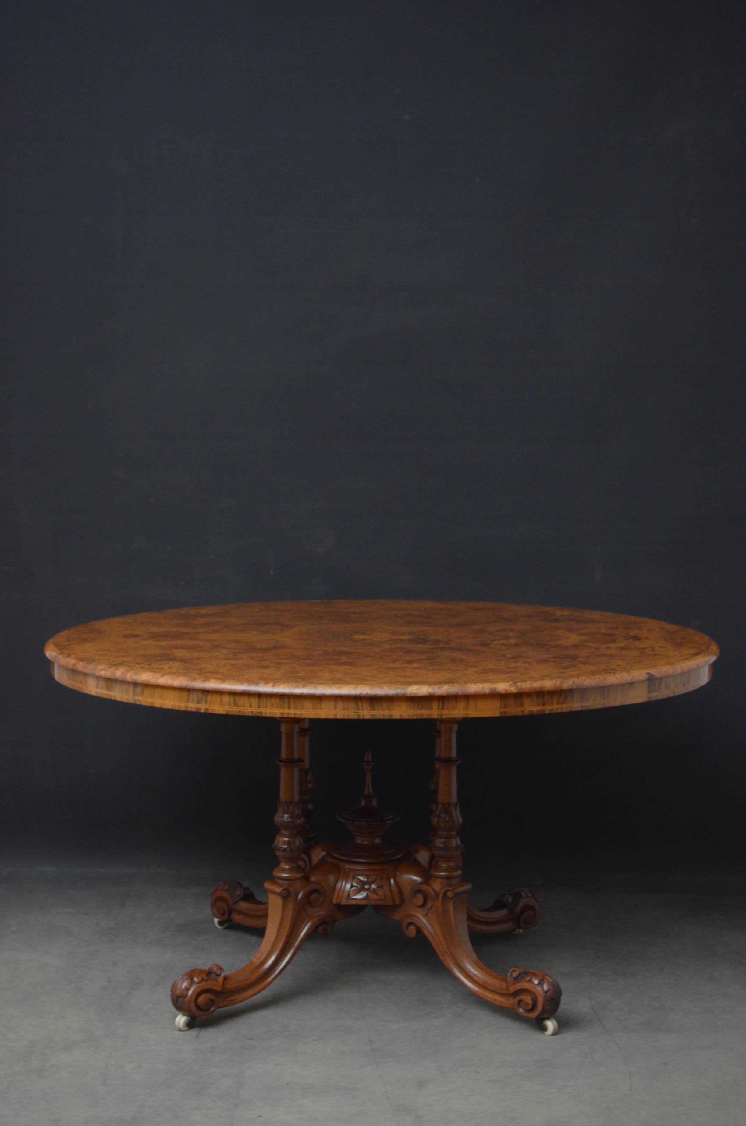 Sn5083 fine Victorian burr walnut tilt top table, having oval top with fabulous grain and satinwood inlays above inlaid frieze, standing on four turned and tulip carved supports terminating in four finely carved downswept legs and original brass