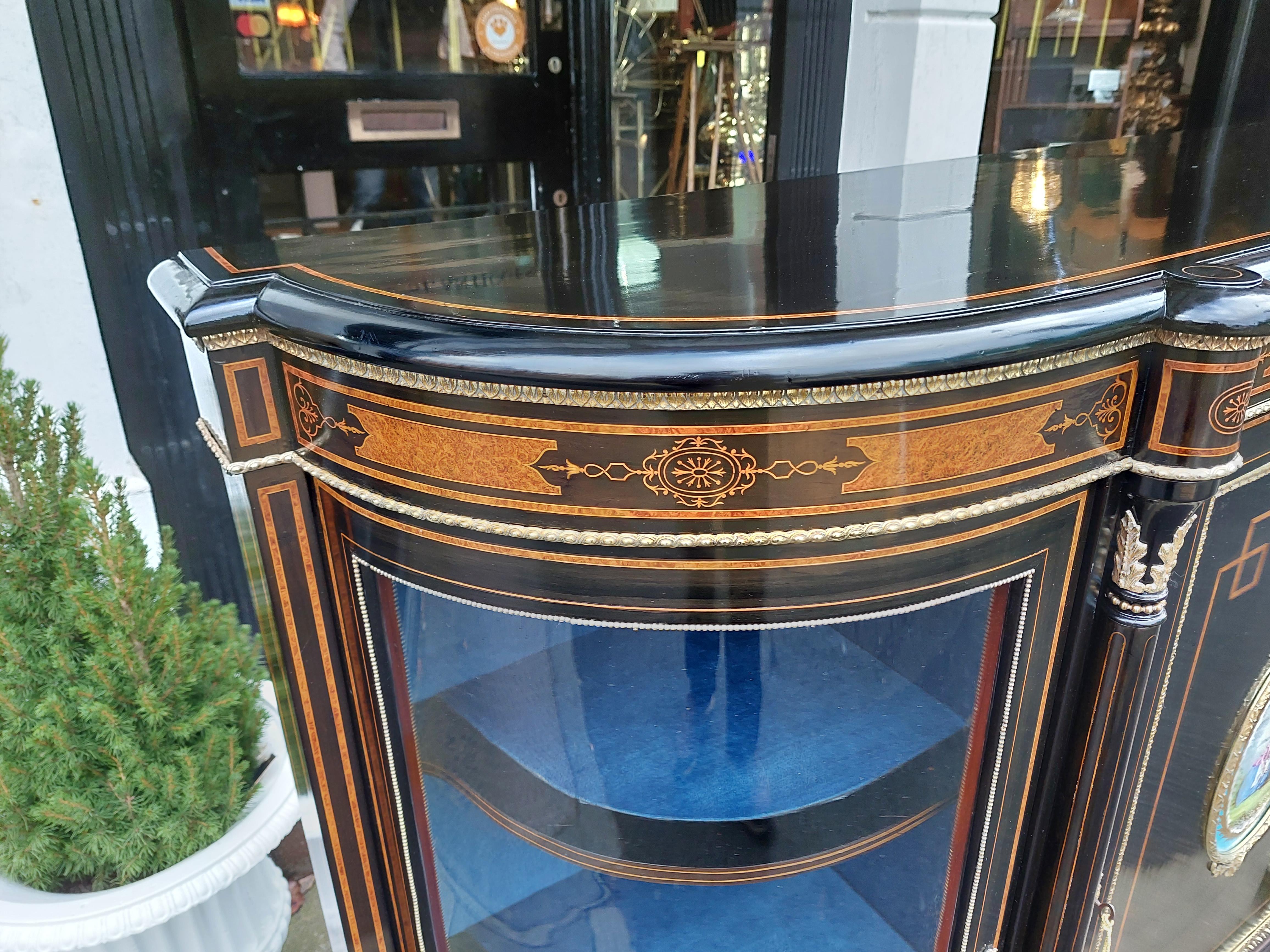 Victorian Walnut, Ebonized & Marquetry  Inlaid Credenza - The side cabinet with central door centered with a porcelain plaque painted with a courting couple, flanked by turned columns and convex glazed doors - 65