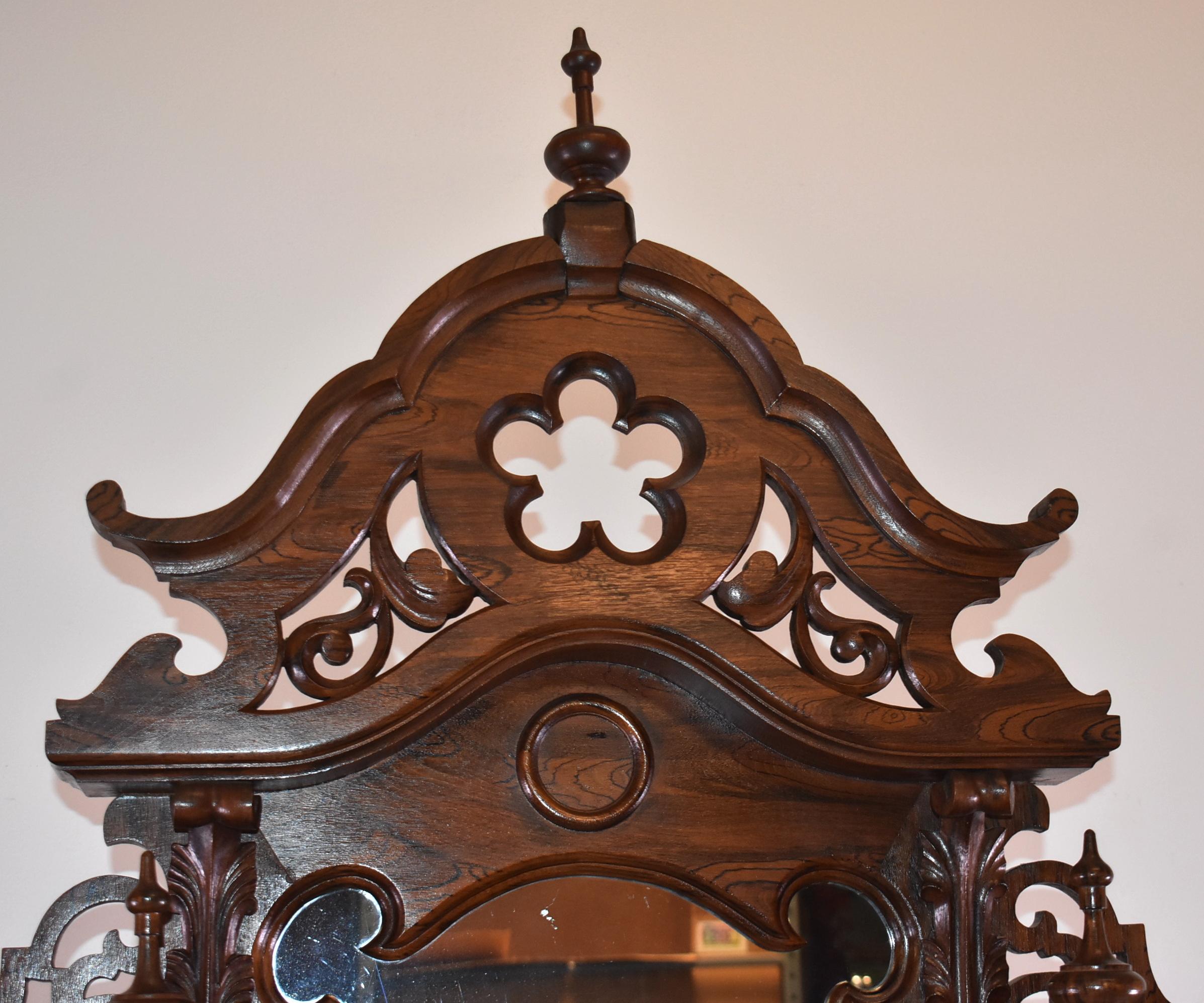 Mitchell & Rammelsberg walnut etagere circa 1880's with 8 shelves, a cut marble center plateau, single drawer, and turned finials. Excellent condition. 89